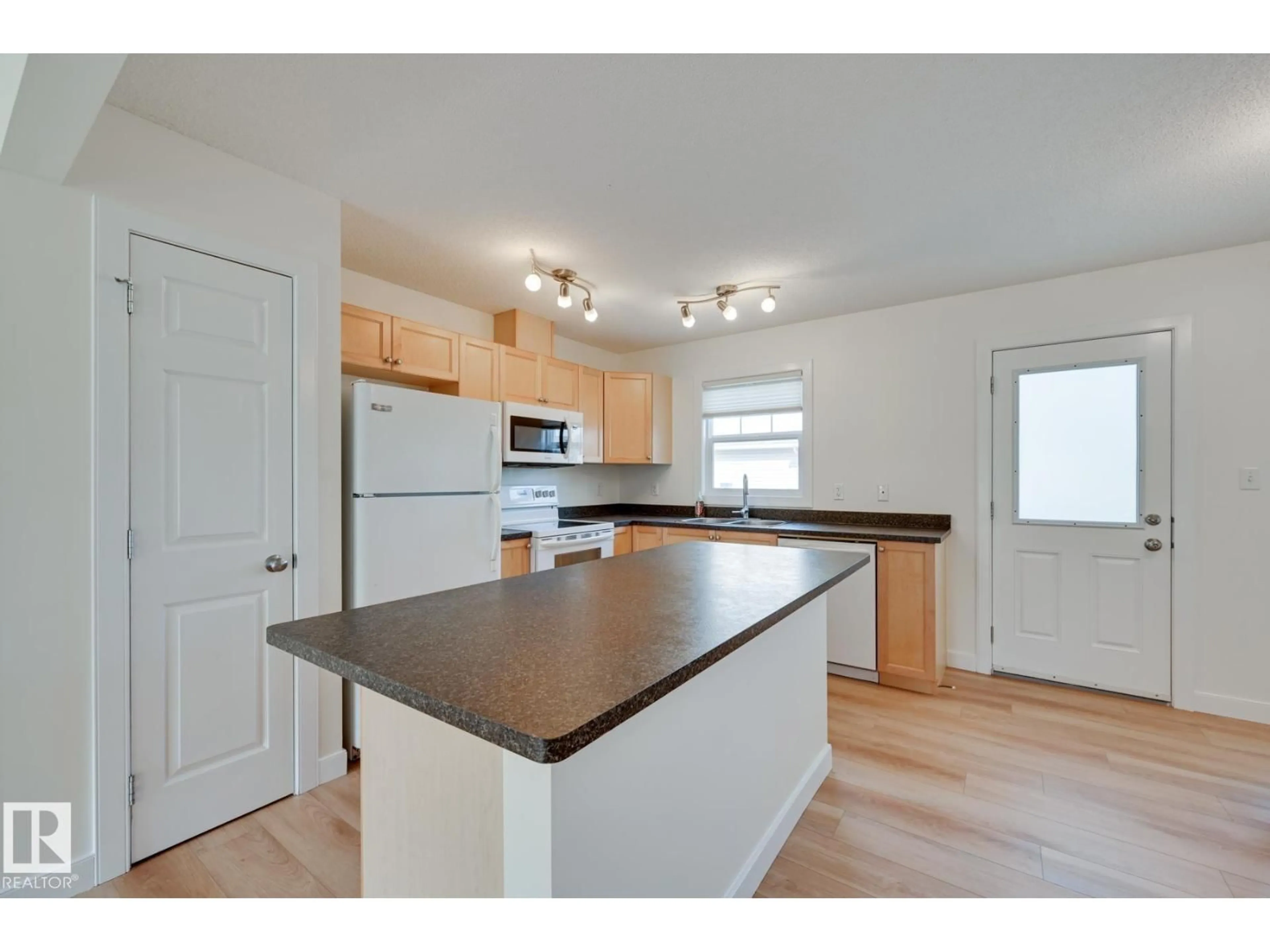 Open concept kitchen, wood/laminate floor for 38 - 6032 38 AV NW, Edmonton Alberta T6L0A4
