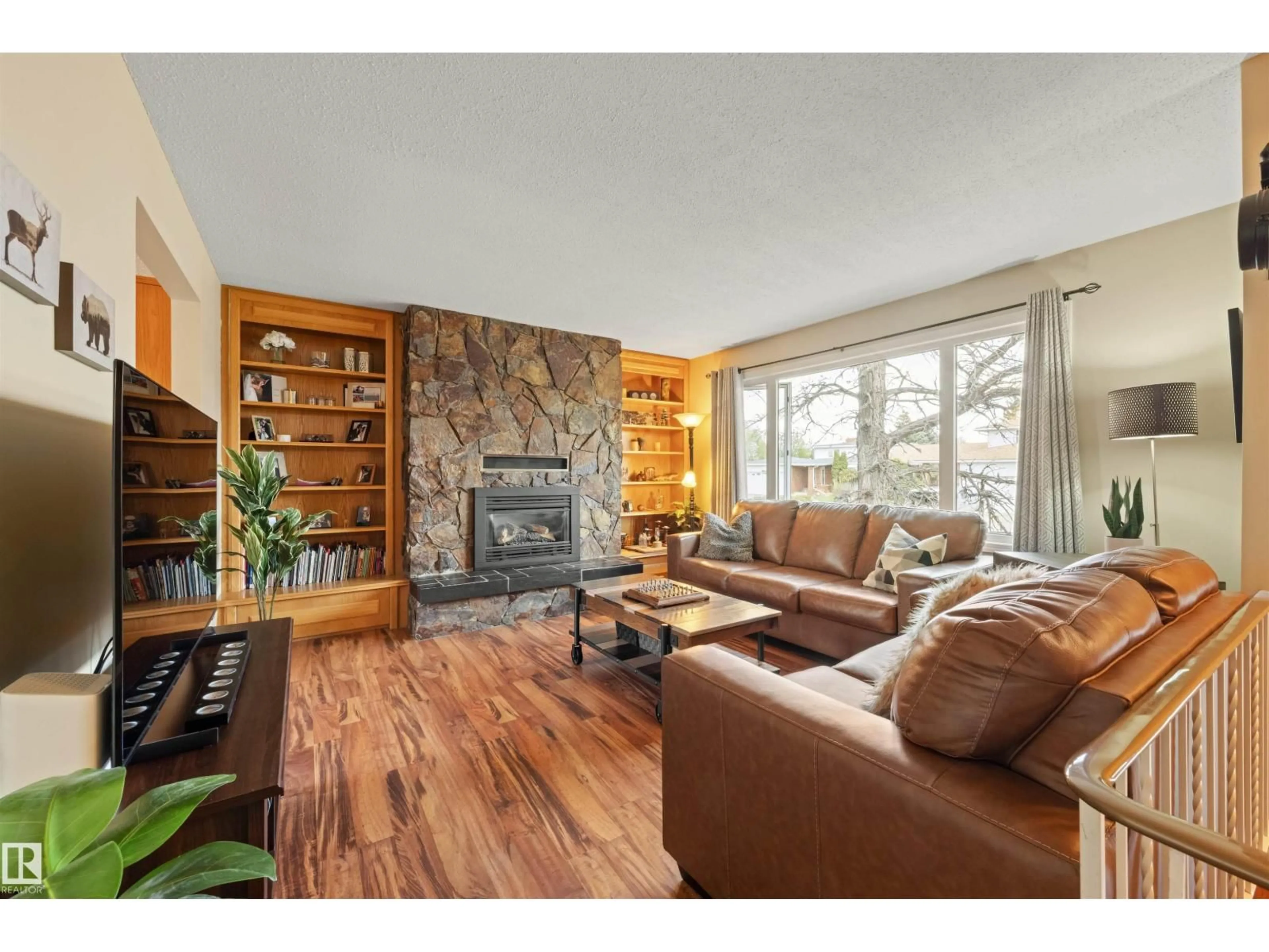 Living room with furniture, wood/laminate floor for 4012 86 ST, Edmonton Alberta T6K1H2