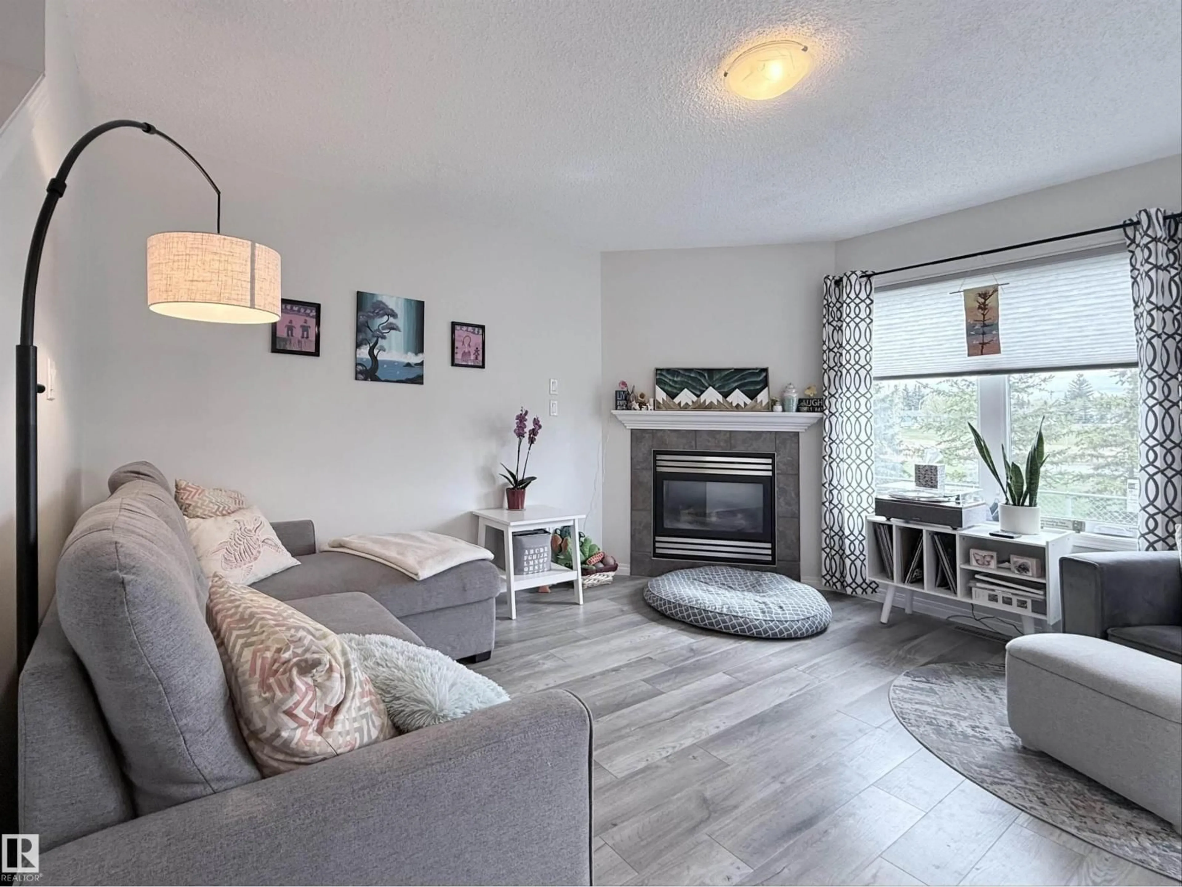 Living room with furniture, wood/laminate floor for 82 5001 62 ST, Beaumont Alberta T4X0C7