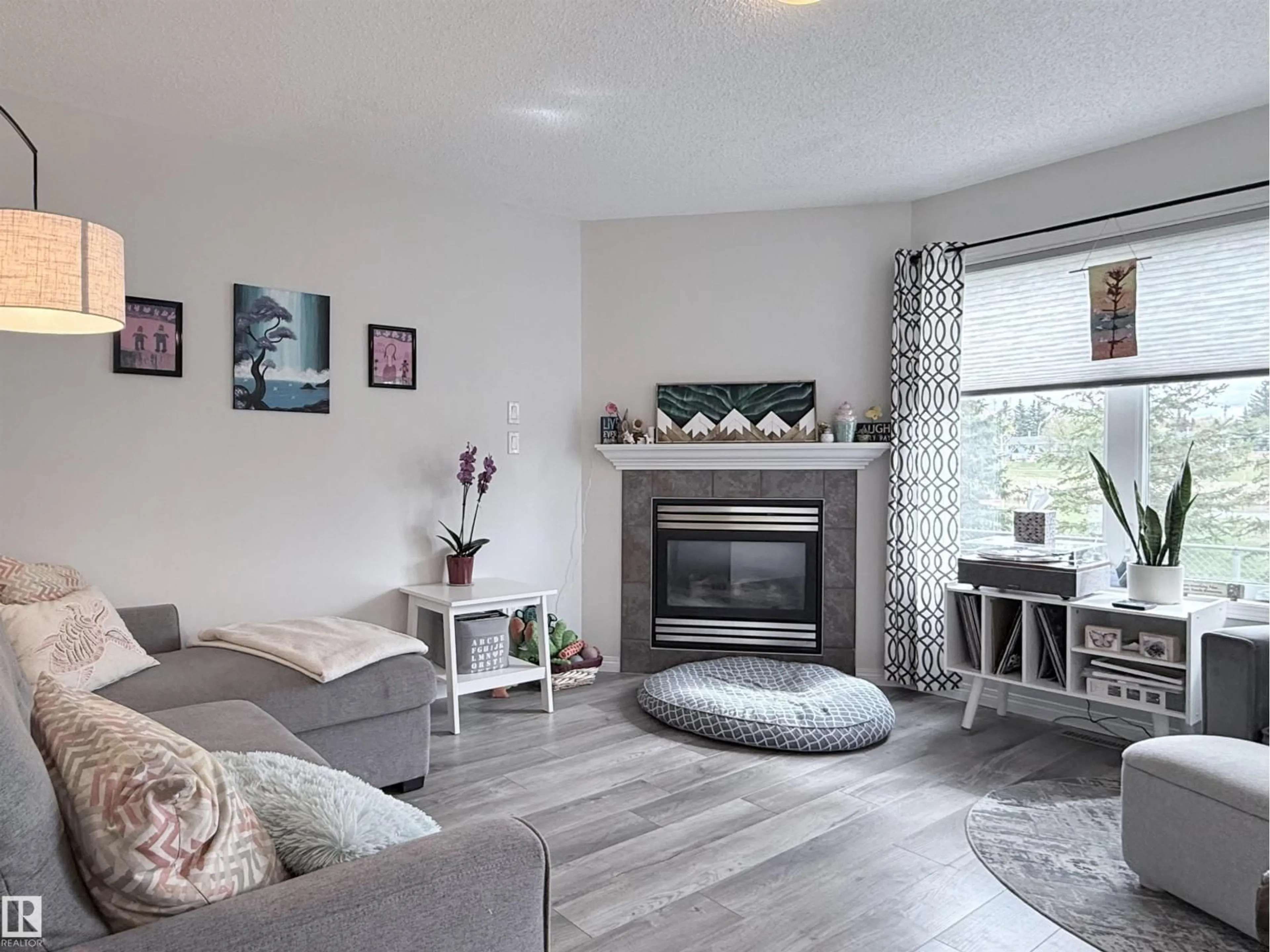 Living room with furniture, wood/laminate floor for 82 5001 62 ST, Beaumont Alberta T4X0C7