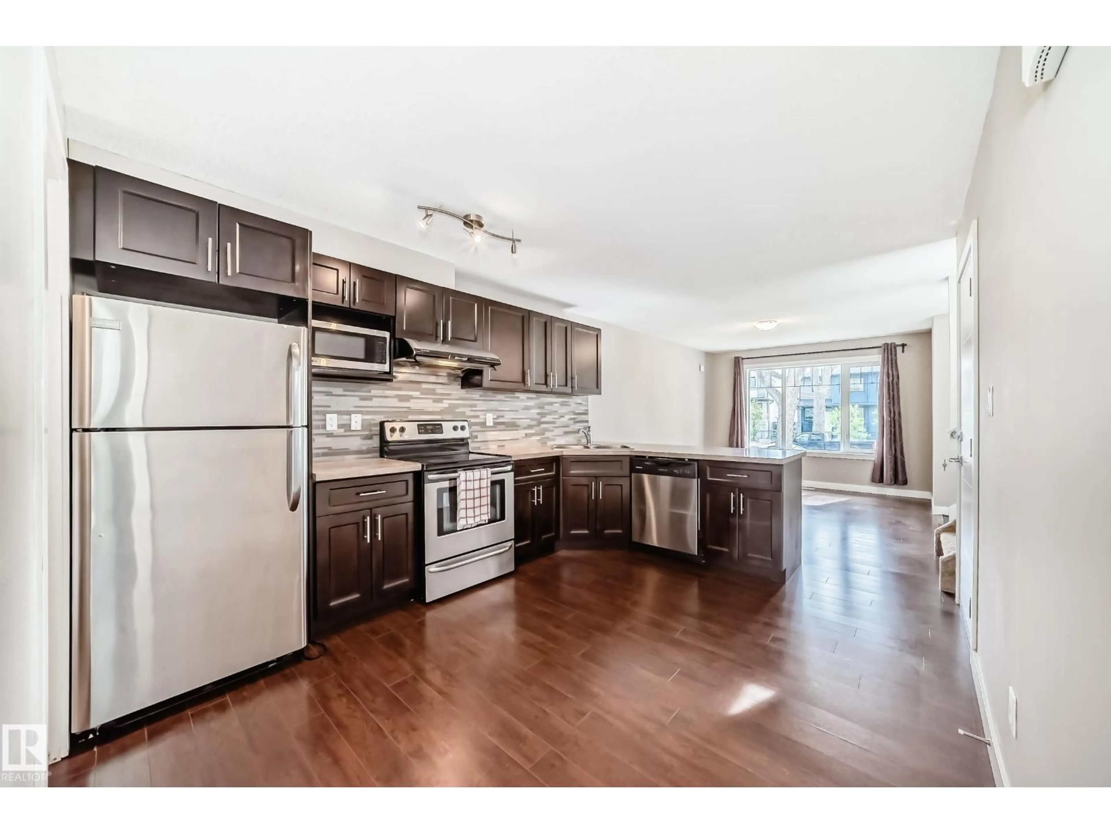 Open concept kitchen, wood/laminate floor for NW - 12118 125 ST, Edmonton Alberta T5L0S6
