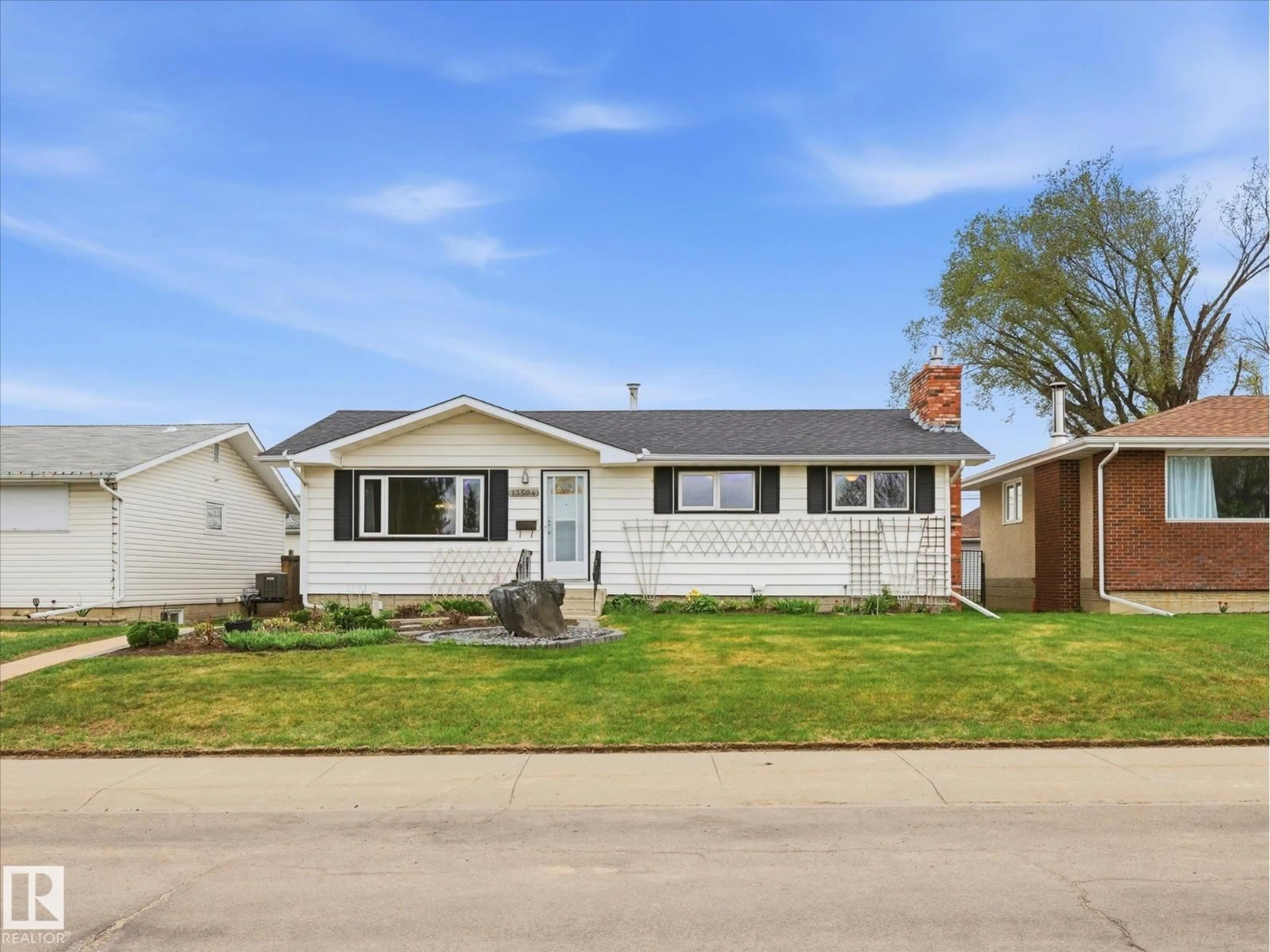 Home with vinyl exterior material, street for 13504 116 ST NW, Edmonton Alberta T5E5J1