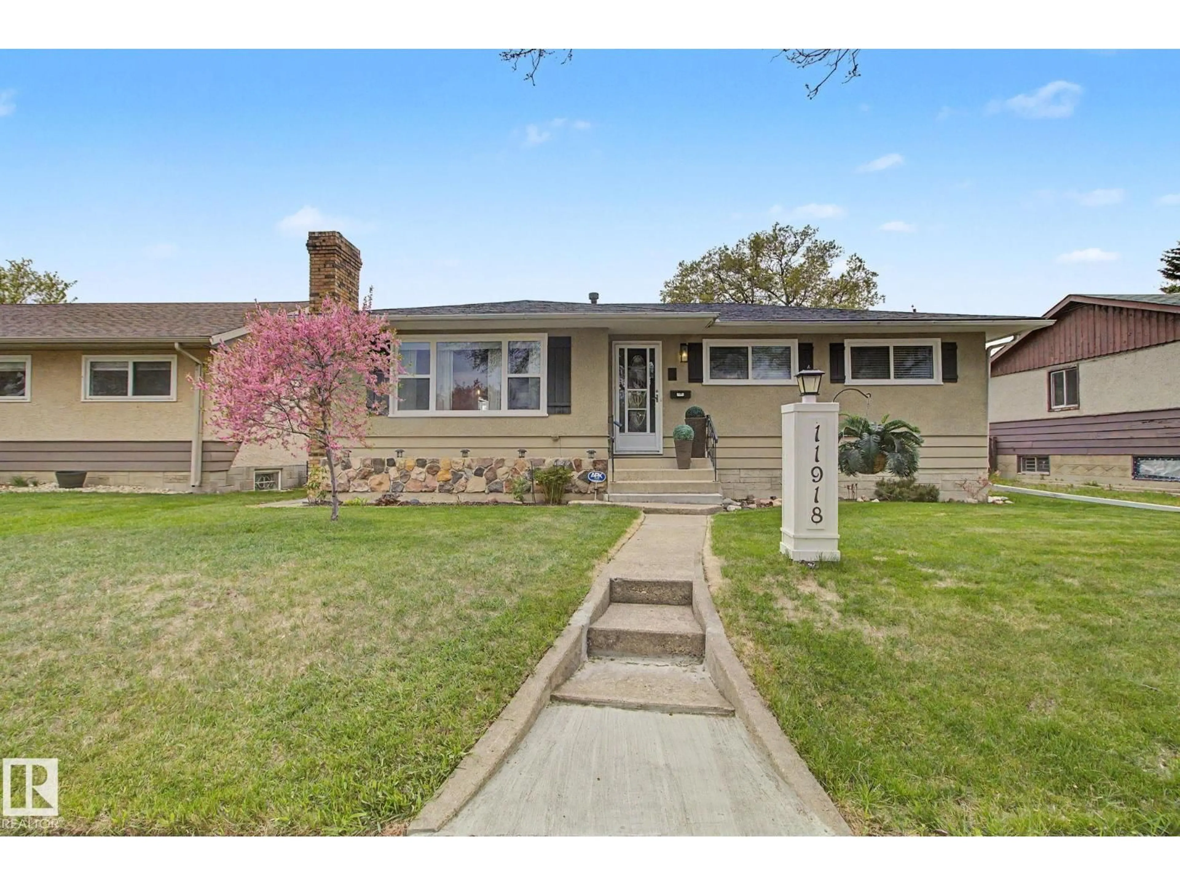 Home with vinyl exterior material, street for NW - 11918 43 ST, Edmonton Alberta T5W2P6