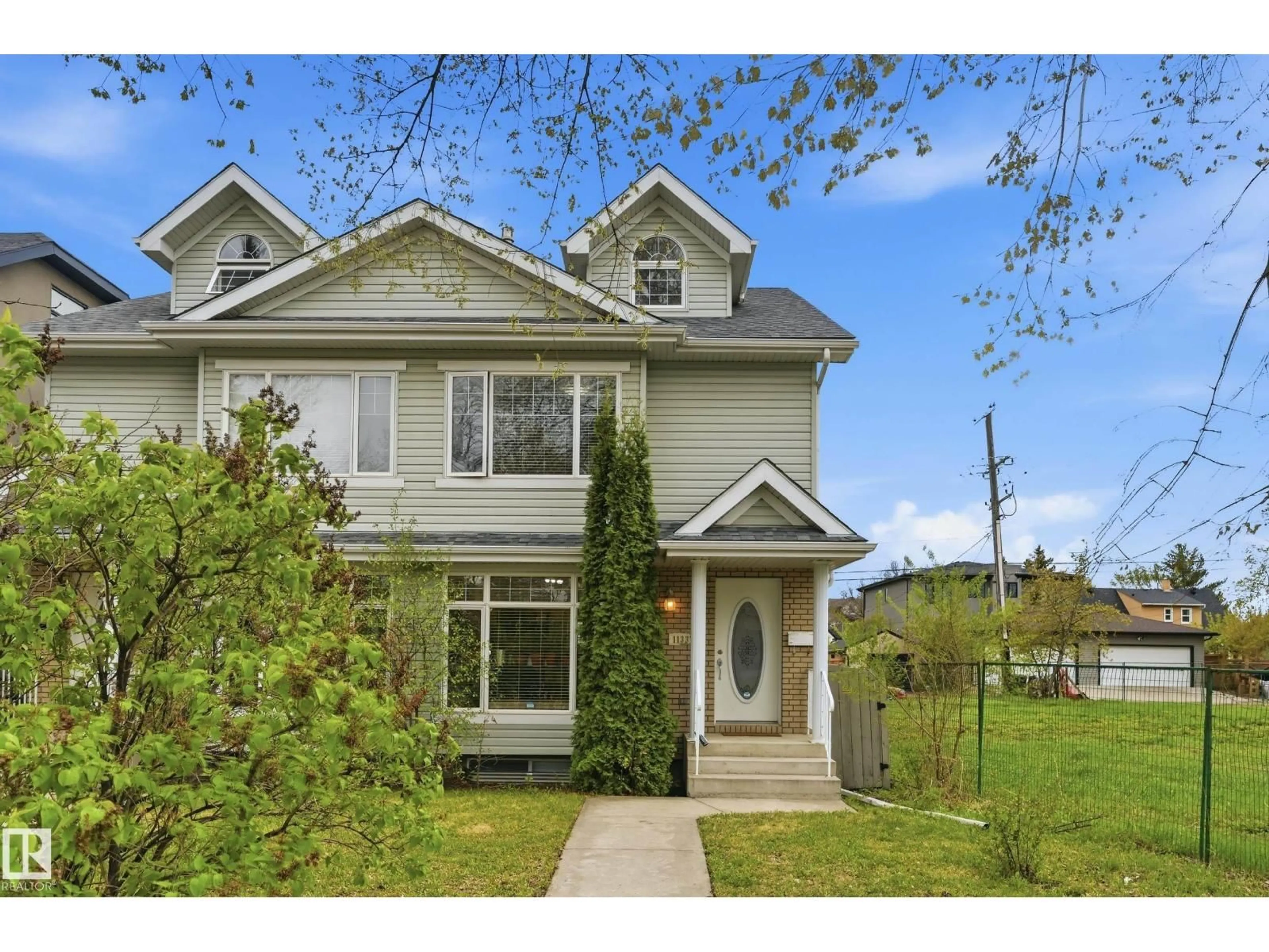 Home with vinyl exterior material, street for 11337 76 AV, Edmonton Alberta T6G0K3