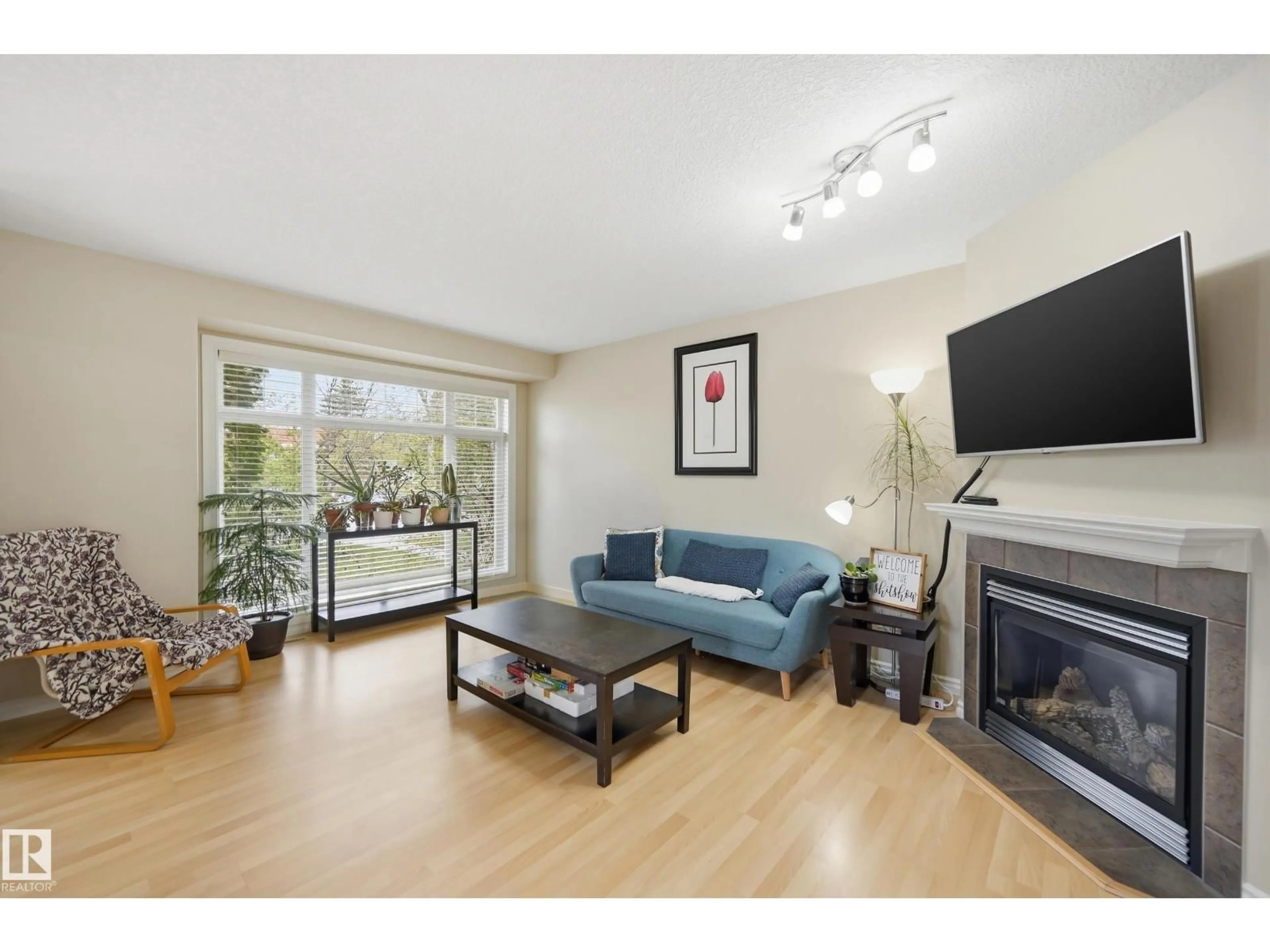 Living room with furniture, wood/laminate floor for 11337 76 AV, Edmonton Alberta T6G0K3