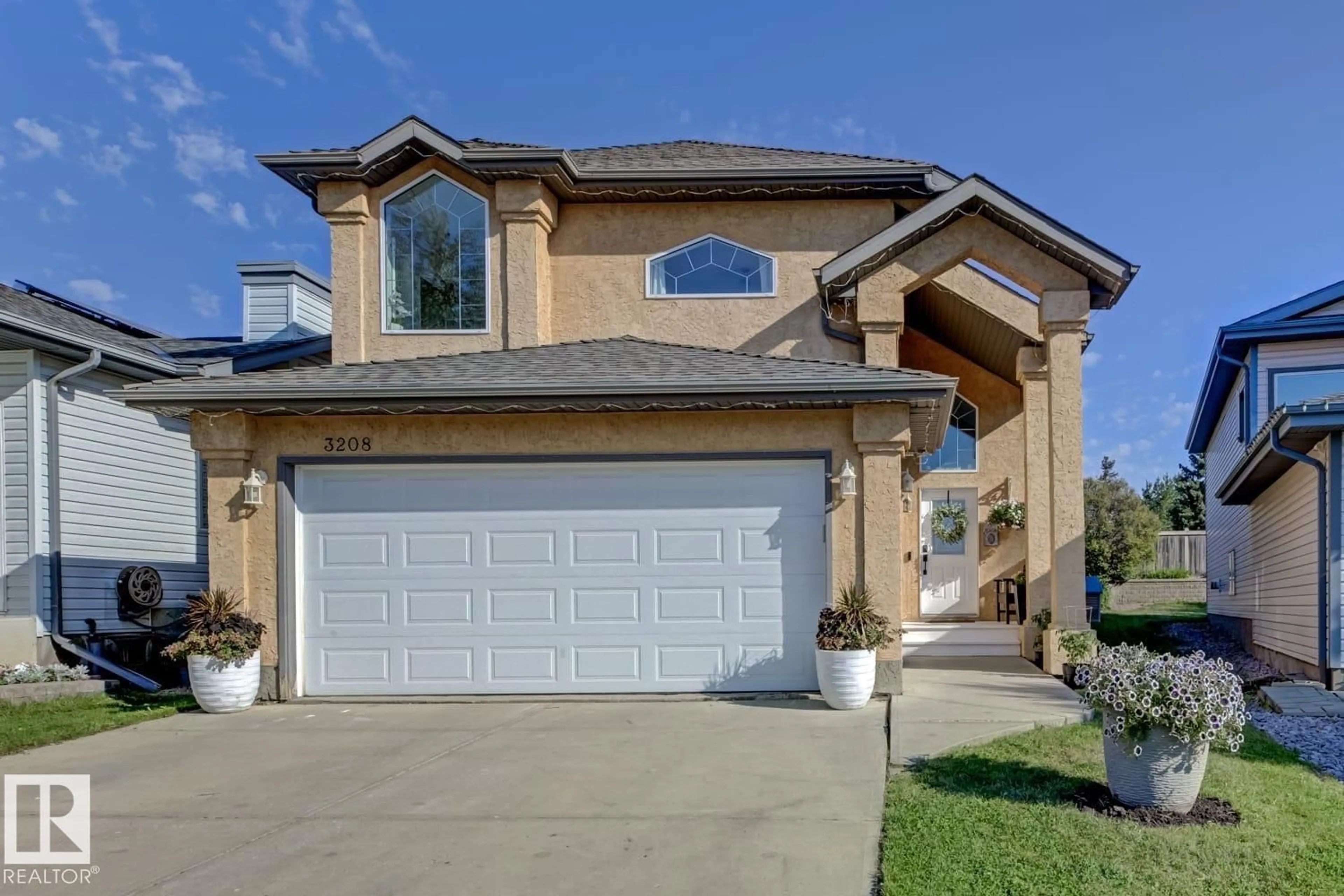 Home with vinyl exterior material, street for 3208 135A AV, Edmonton Alberta T5A5E3