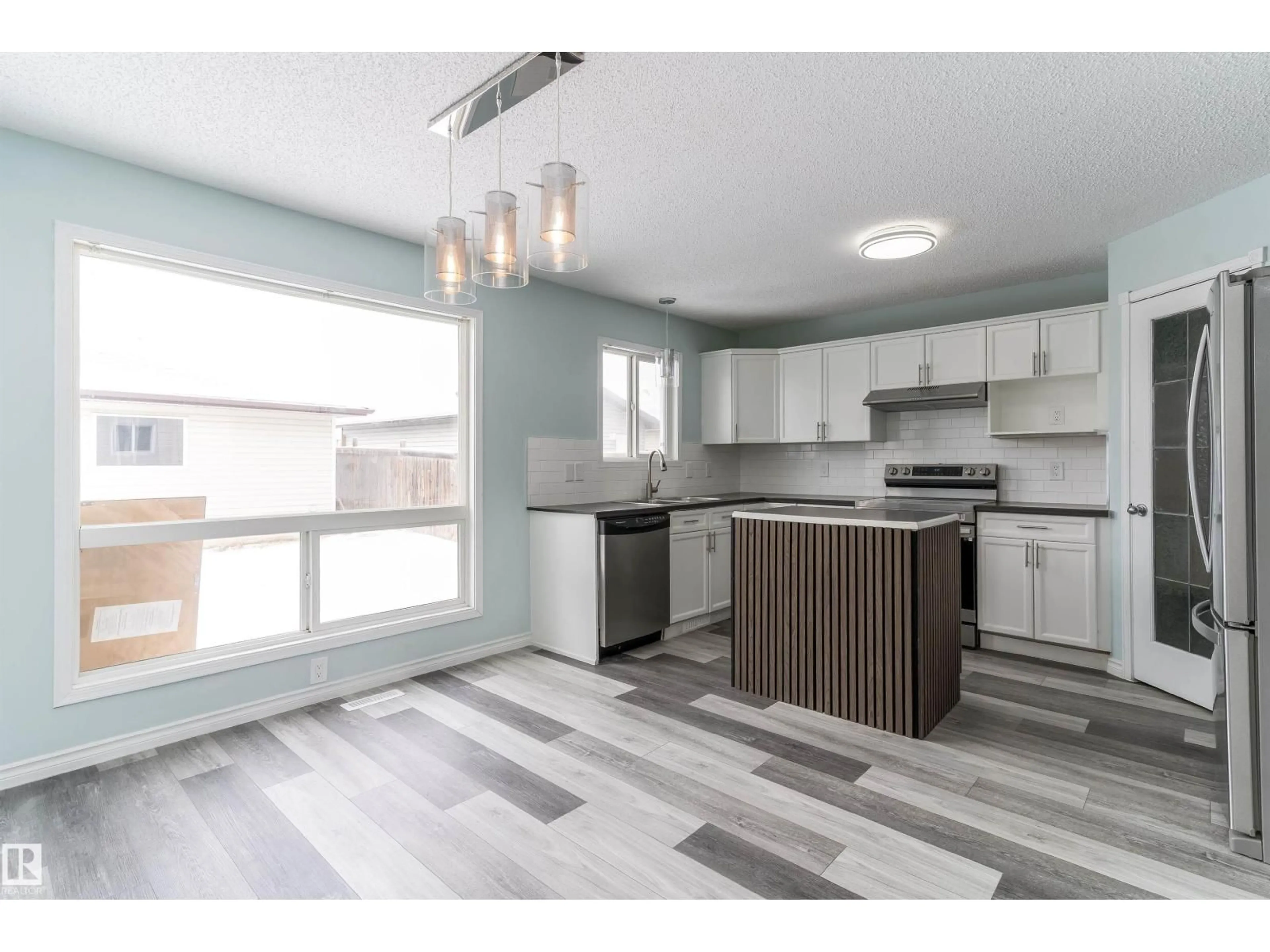 Open concept kitchen, wood/laminate floor for NW - 16304 43 ST, Edmonton Alberta T5Y0H8