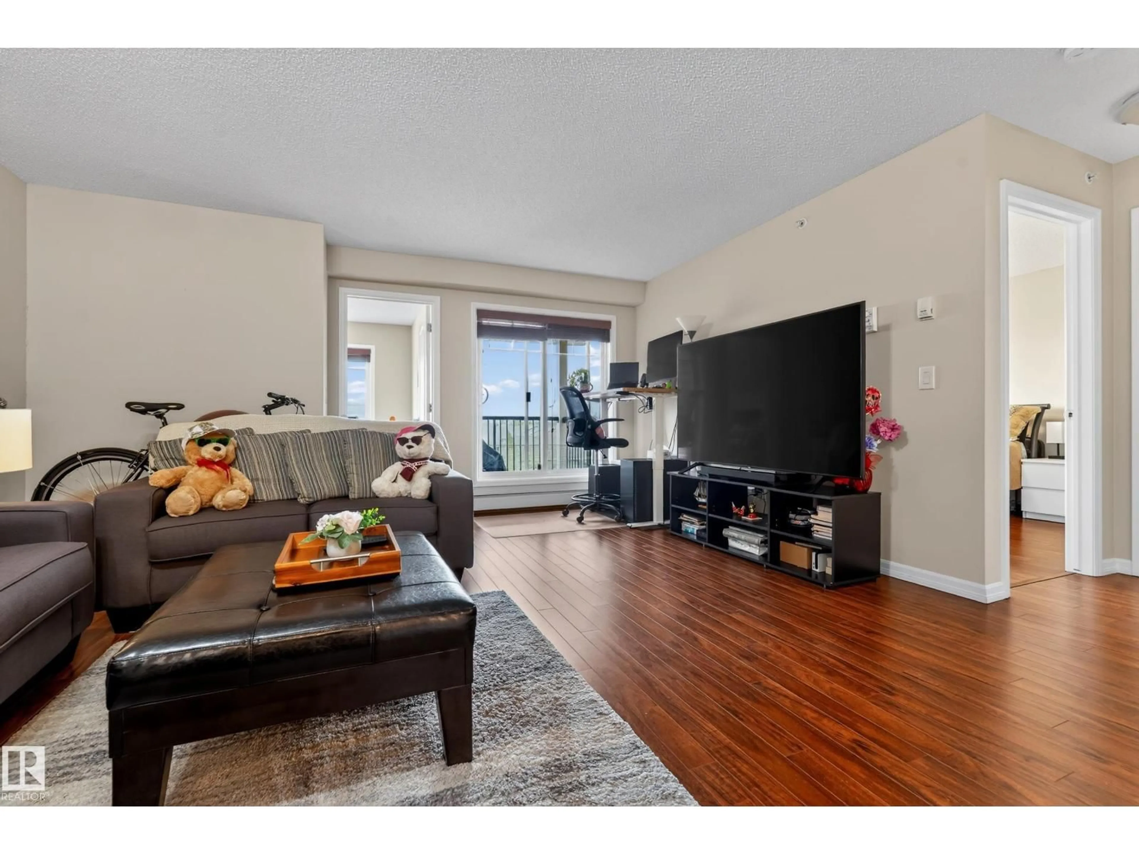 Living room with furniture, wood/laminate floor for #419 - 271 CHARLOTTE WY, Sherwood Park Alberta T8H0N9
