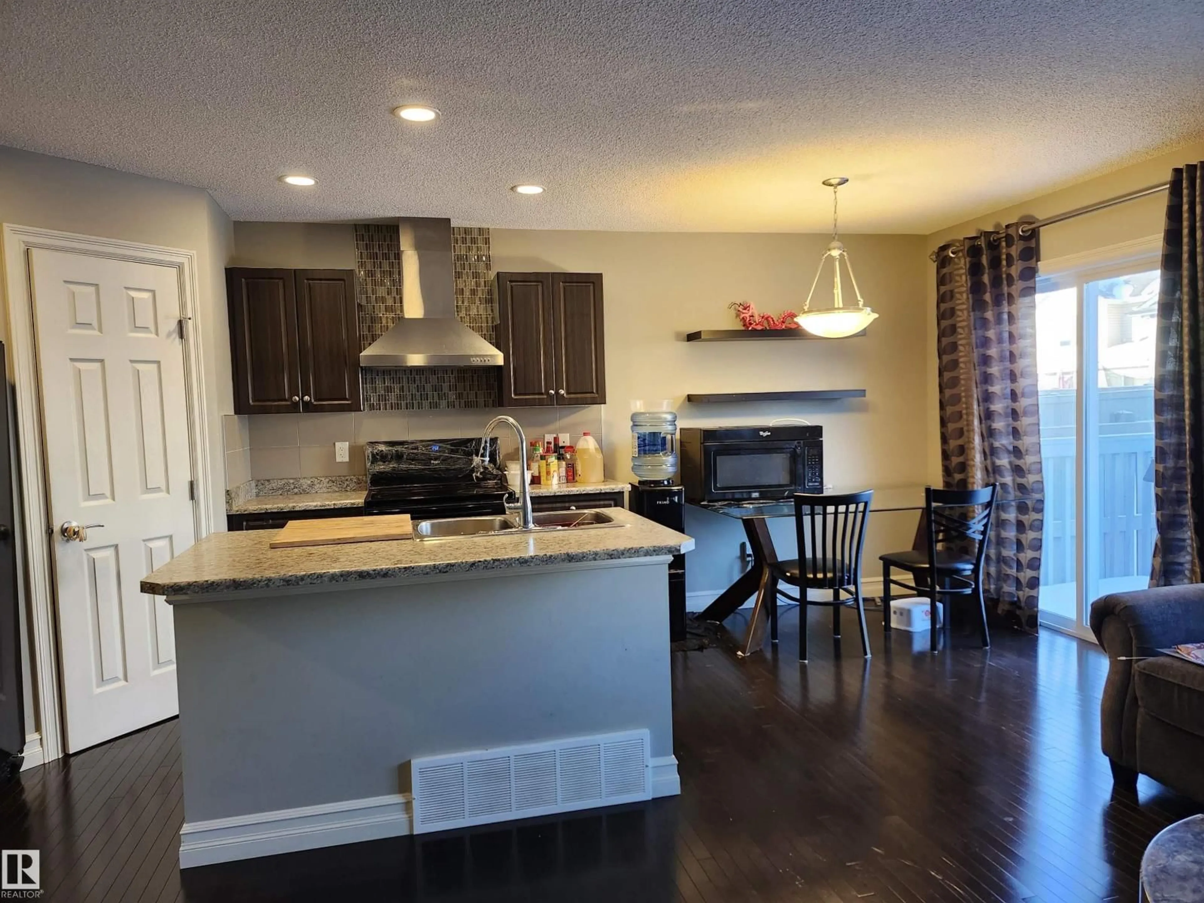 Open concept kitchen, wood/laminate floor for NW - 12026 167B AV, Edmonton Alberta T5X0G6