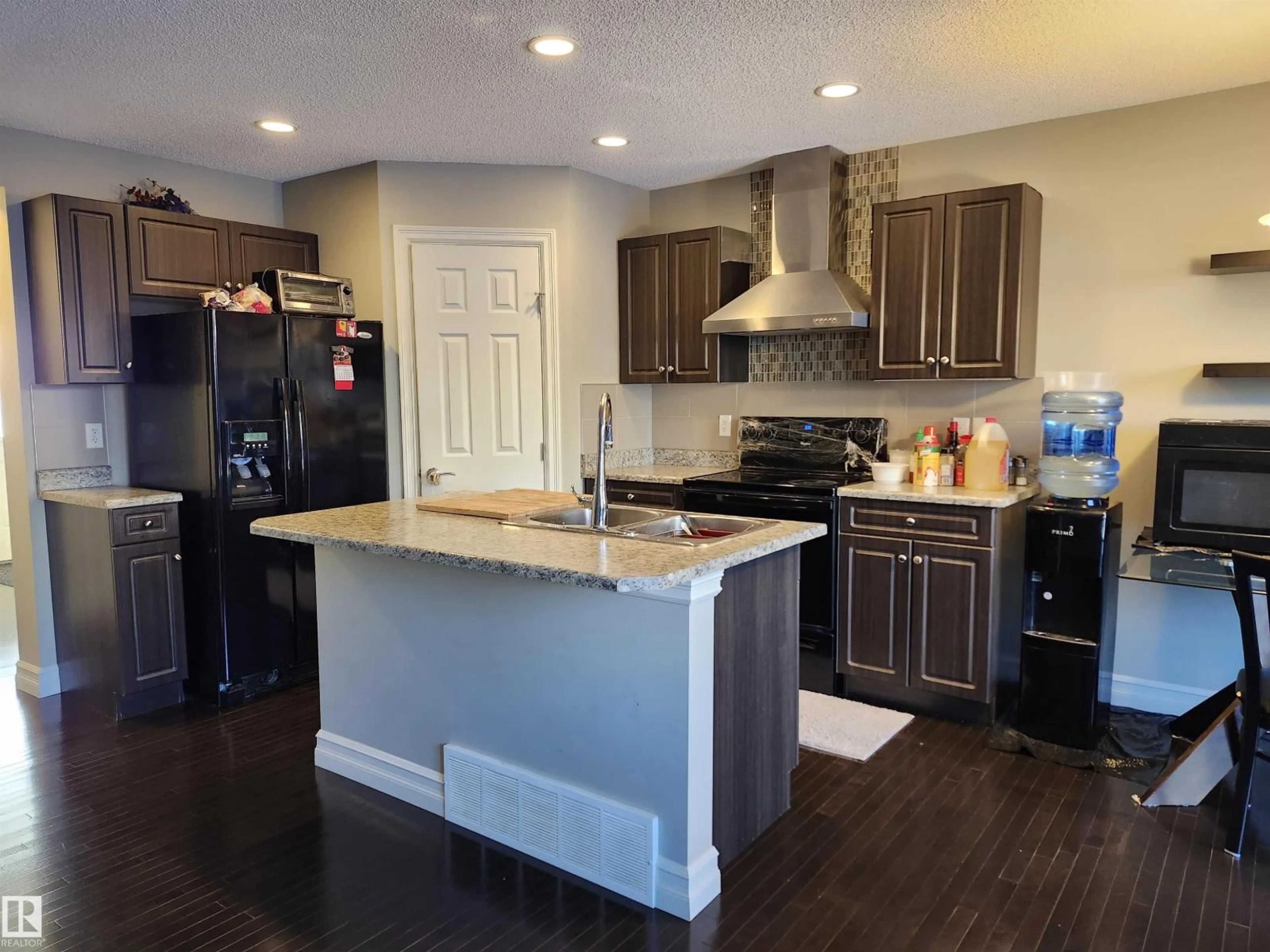 Open concept kitchen, wood/laminate floor for NW - 12026 167B AV, Edmonton Alberta T5X0G6