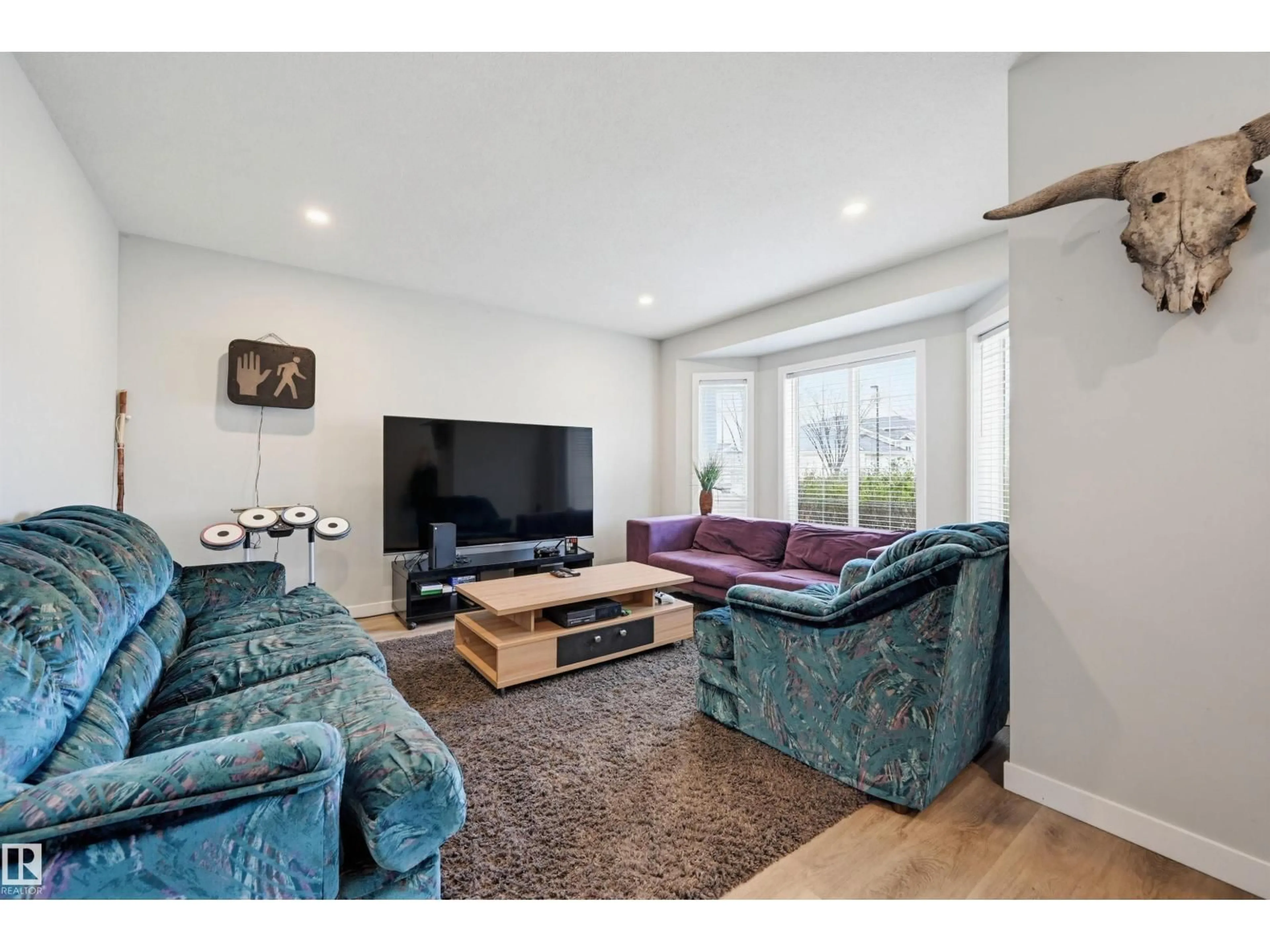 Living room with furniture, wood/laminate floor for 11 - 3380 28A AV, Edmonton Alberta T6T1V4