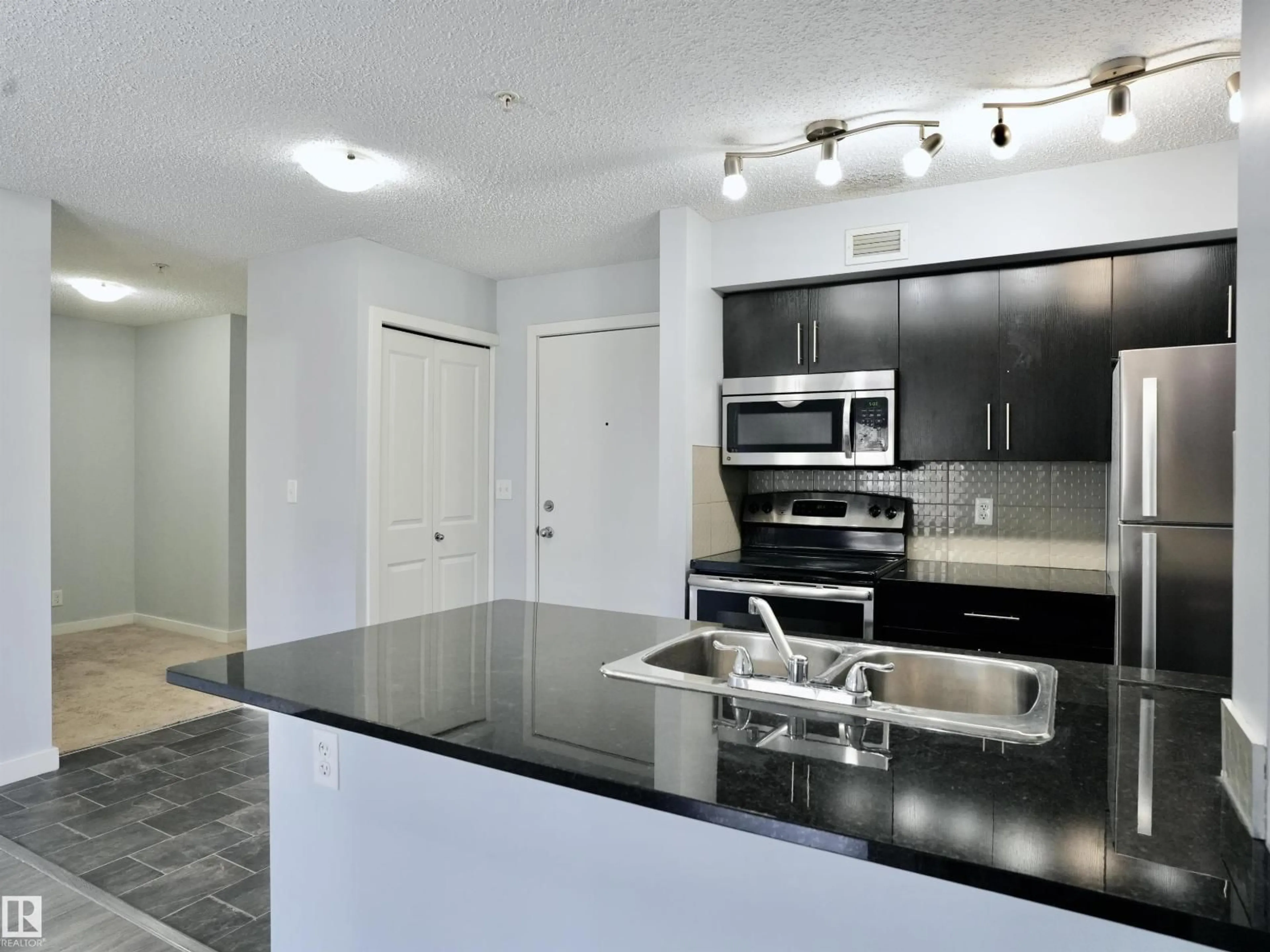 Open concept kitchen, unknown for #320 - 5816 MULLEN PL, Edmonton Alberta T6R0W3