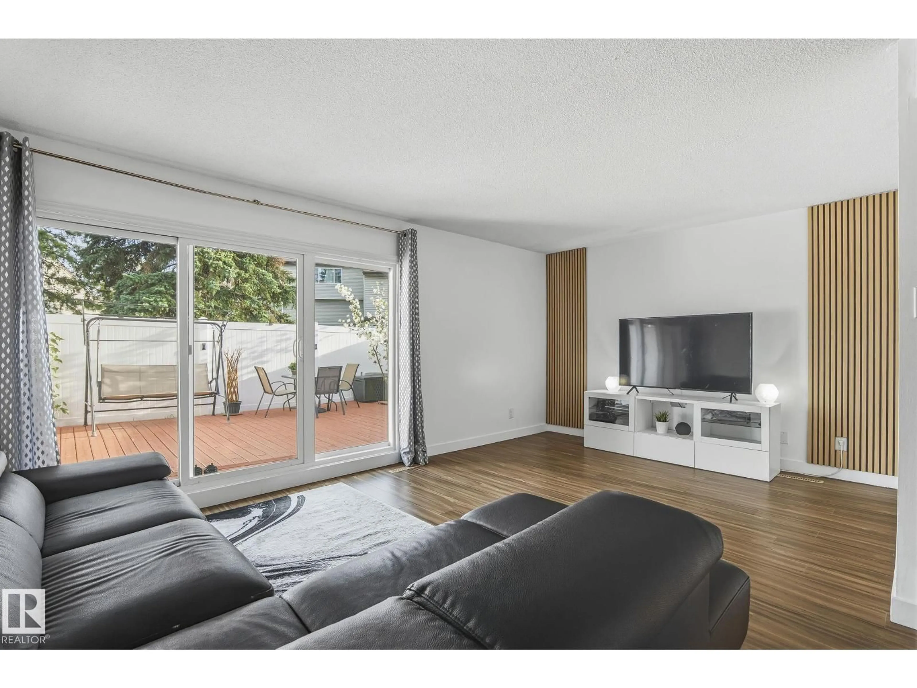Living room with furniture, wood/laminate floor for 28C MEADOWLARK VILLAGE, Edmonton Alberta T5R5X4