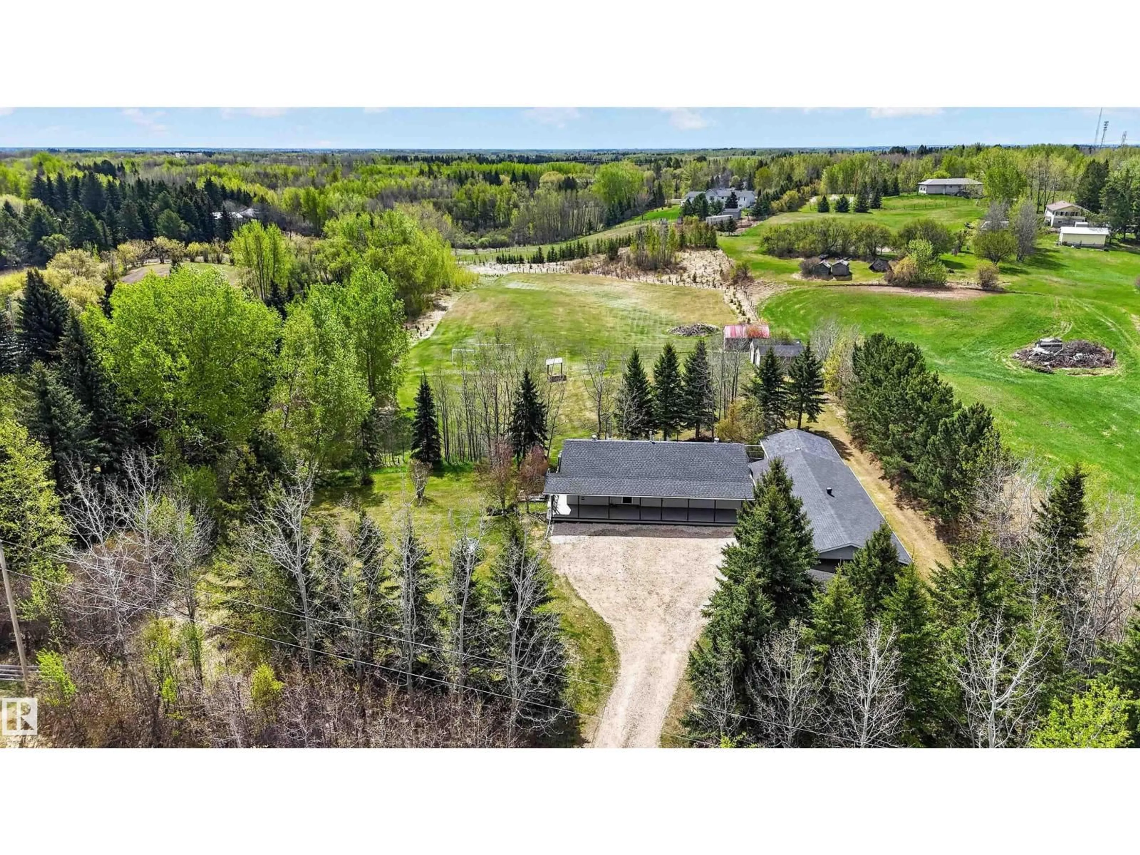 A pic from outside/outdoor area/front of a property/back of a property/a pic from drone, forest/trees view for #3 - 53227 RGE ROAD 15, Rural Parkland County Alberta T7Y0C3