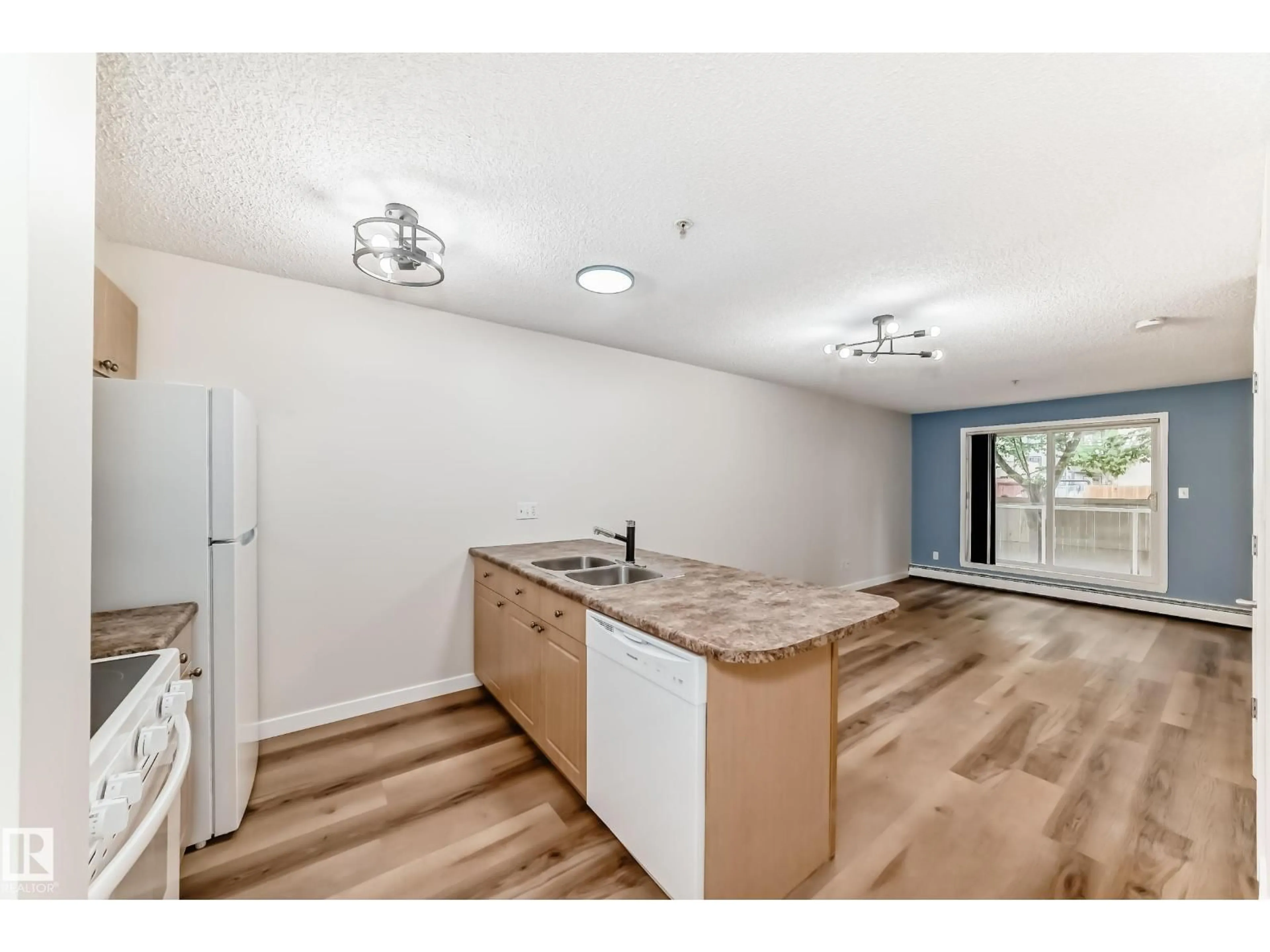 Open concept kitchen, wood/laminate floor for #108 - 12838 65 ST, Edmonton Alberta T5A5H3