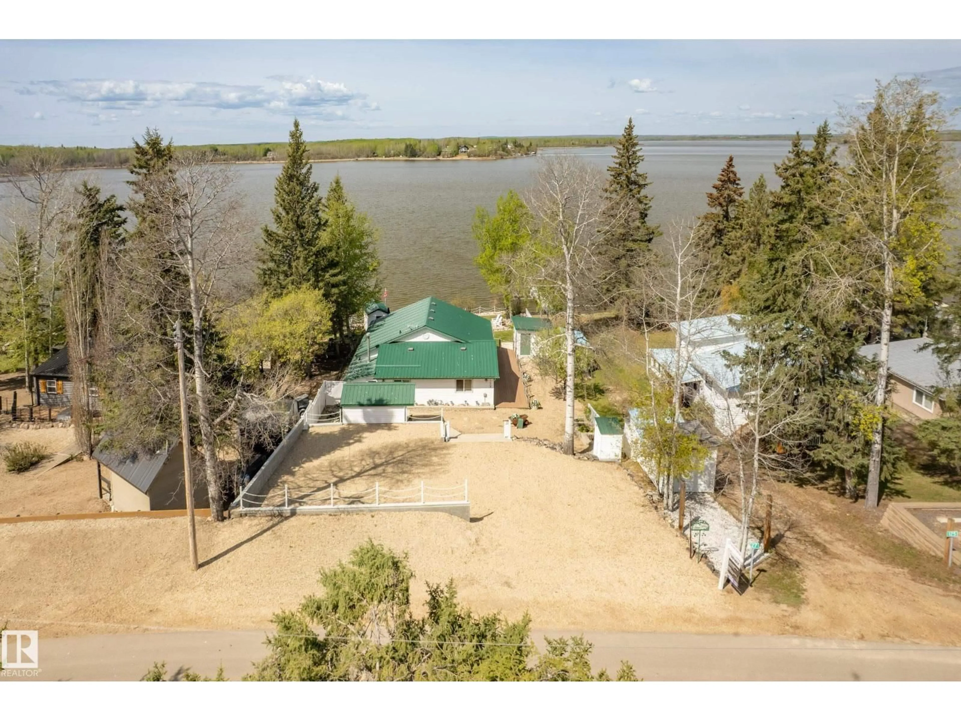 A pic from outside/outdoor area/front of a property/back of a property/a pic from drone, water/lake/river/ocean view for 127 - 5415 TWP RD 594, Rural Barrhead County Alberta T7X1N3