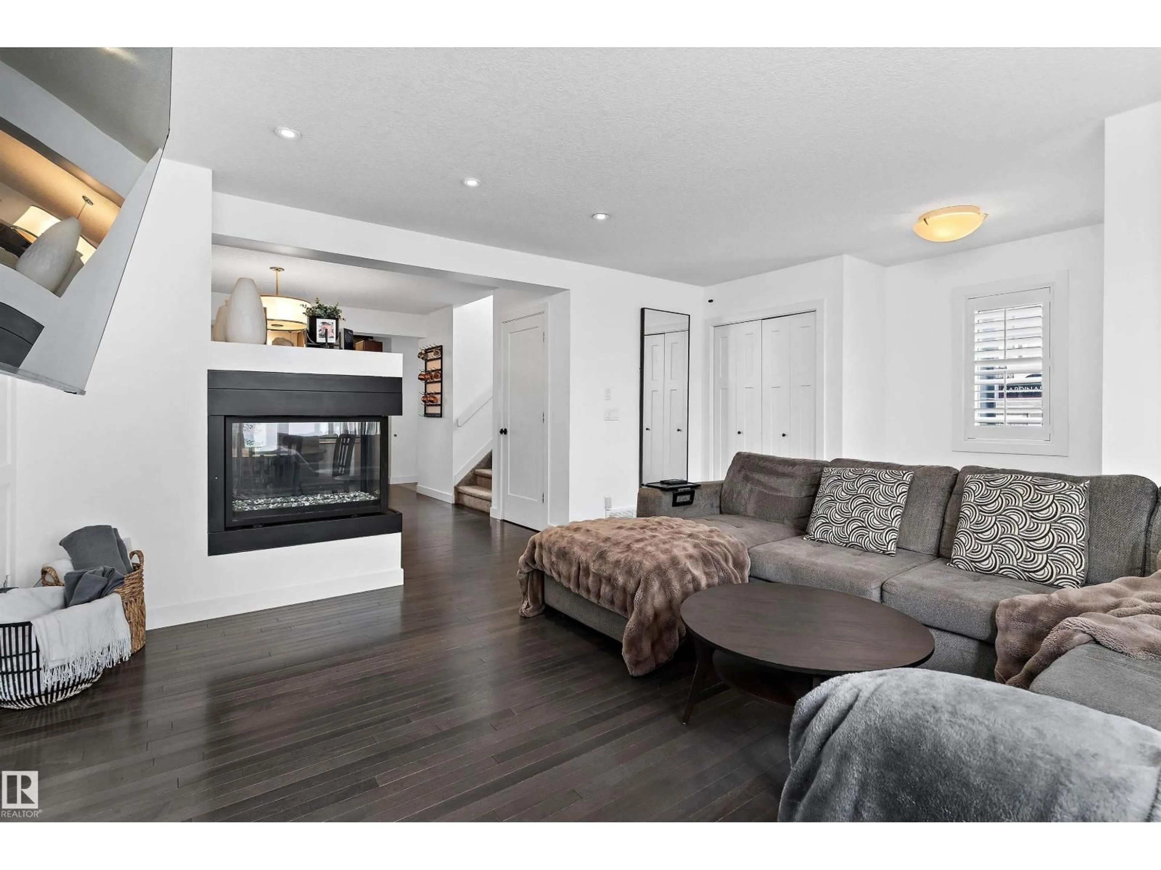 Living room with furniture, wood/laminate floor for 6904 CARDINAL WD, Edmonton Alberta T6W2Y4