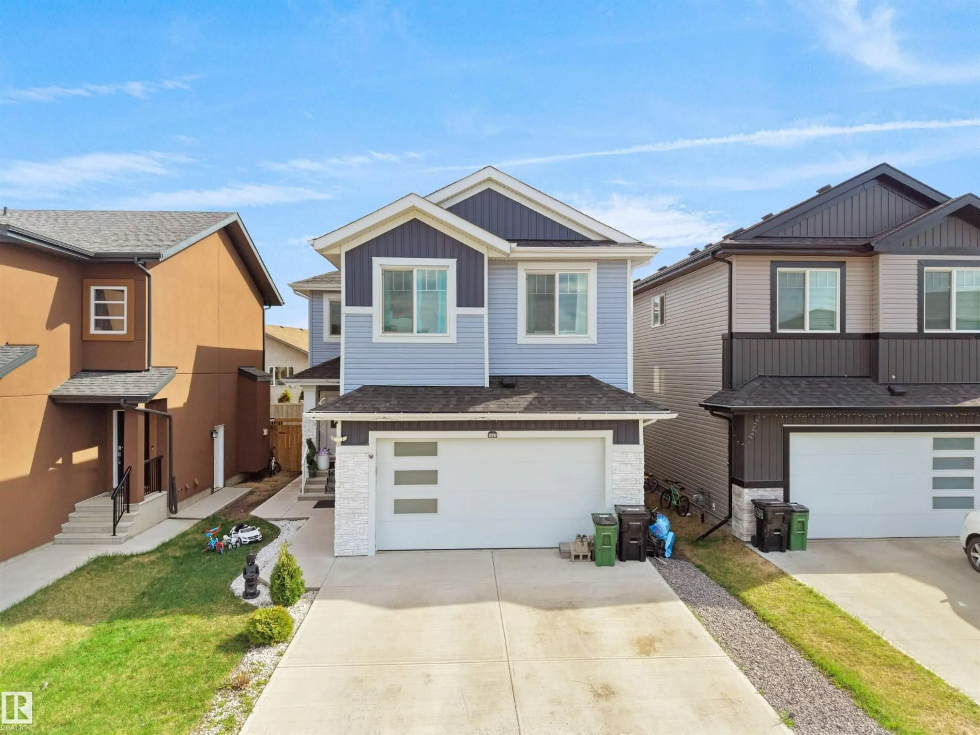 Home with vinyl exterior material, street for 1427 150 AV, Edmonton Alberta T5Y3R5