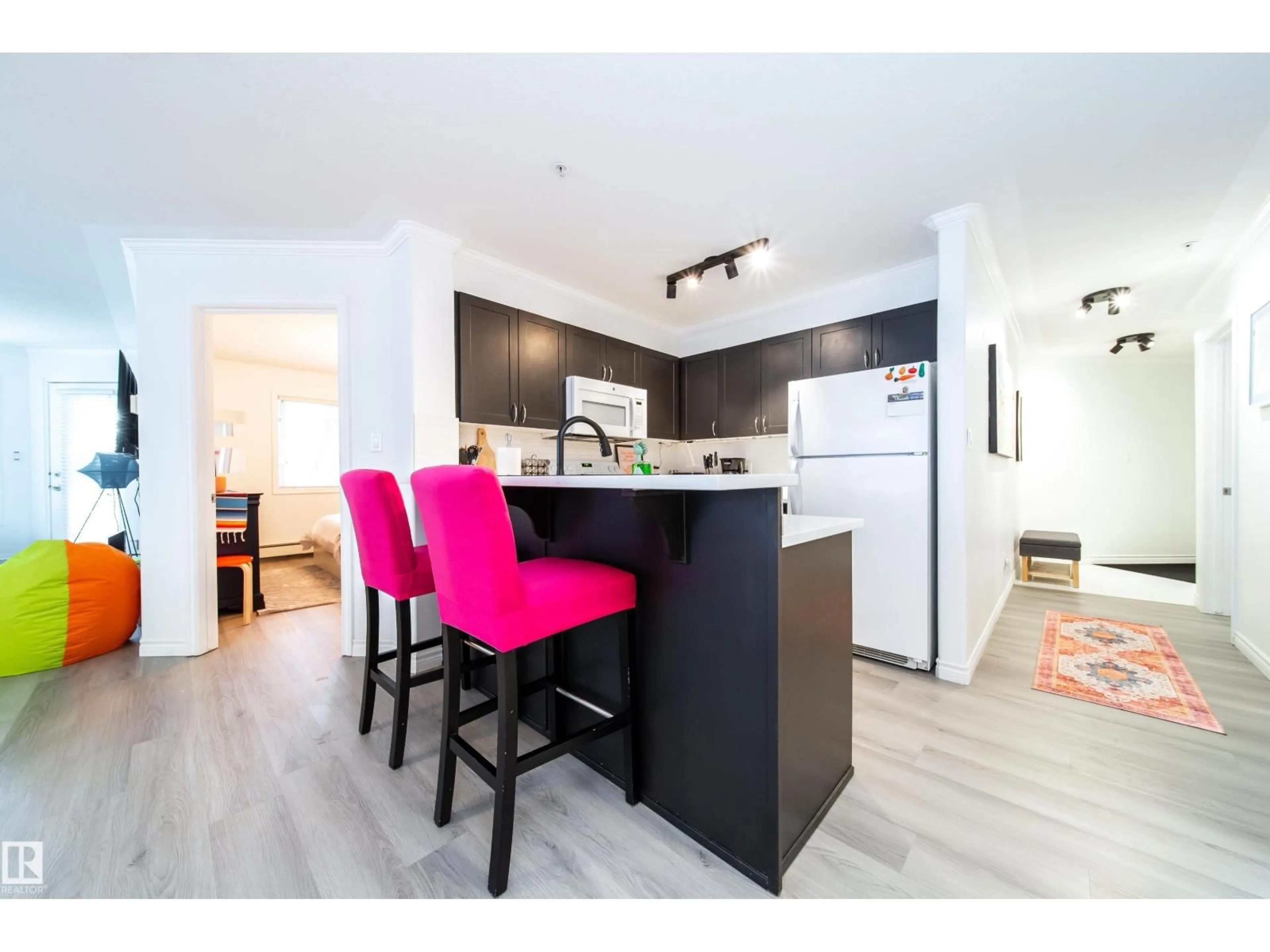 Open concept kitchen, wood/laminate floor for #303 - 9938 104 ST NW, Edmonton Alberta T5K2X7