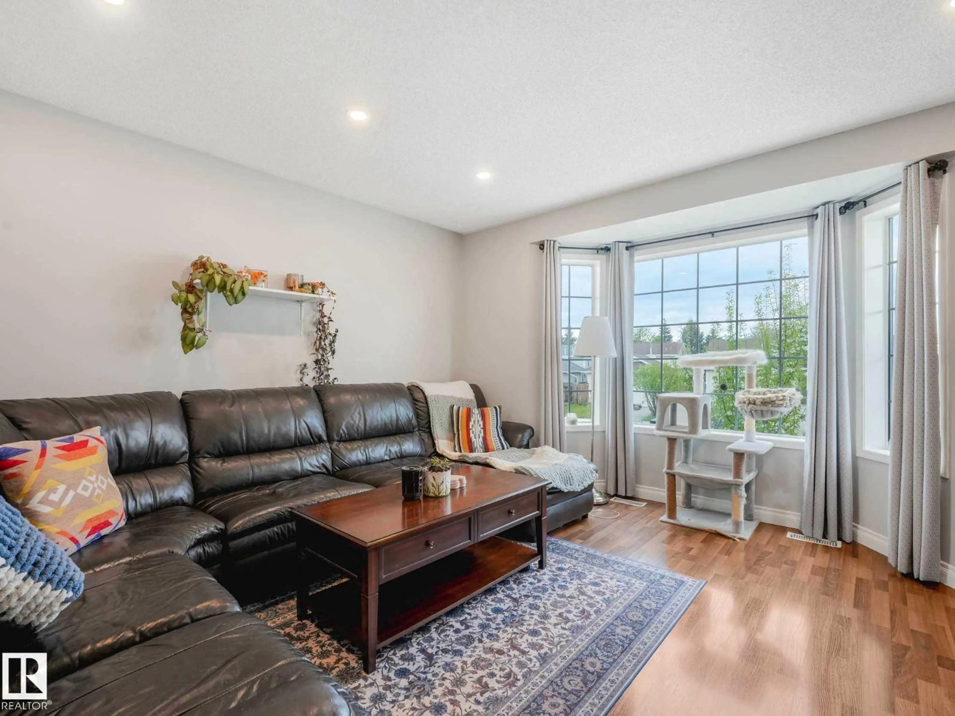 Living room with furniture, wood/laminate floor for 317 KLINE CR, Edmonton Alberta T6L6K8