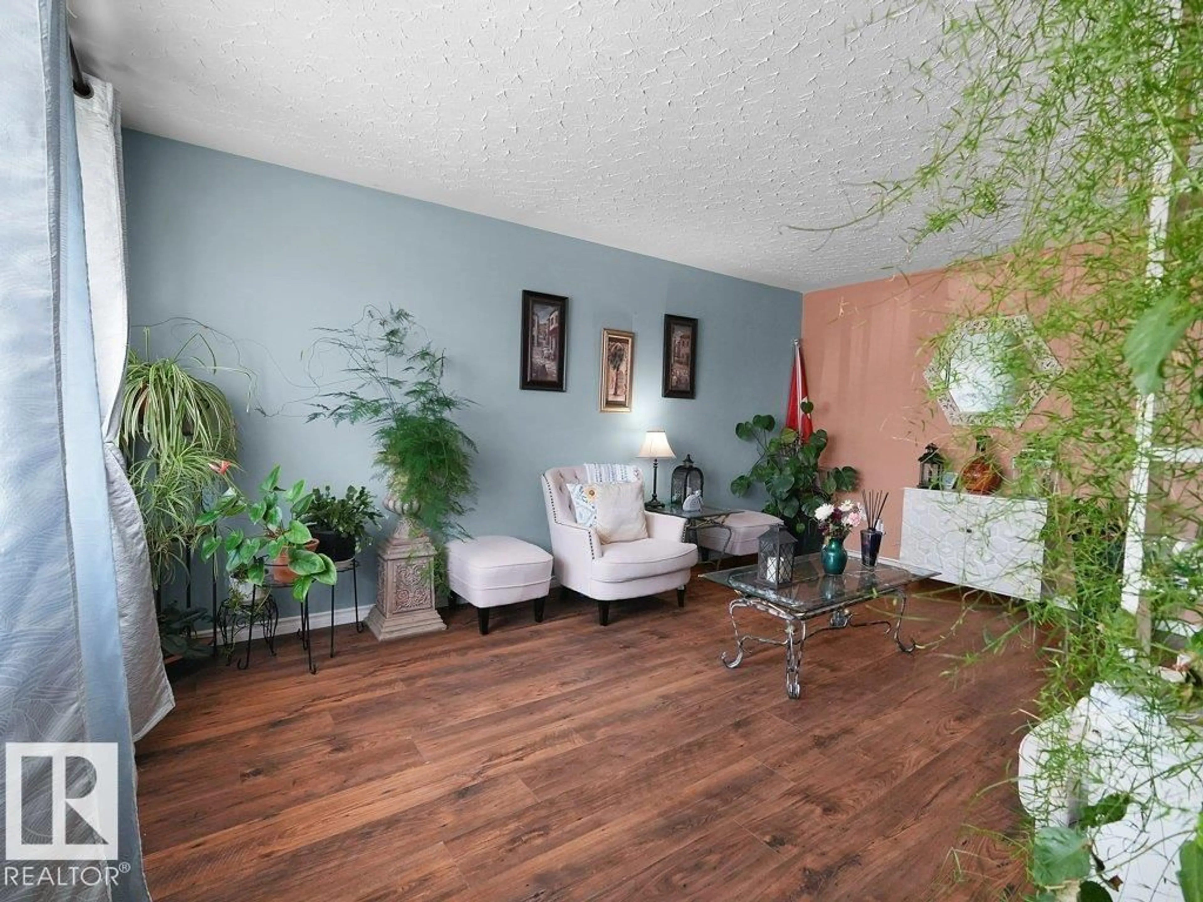 Living room with furniture, wood/laminate floor for 6324 132 AV, Edmonton Alberta T5A0J7