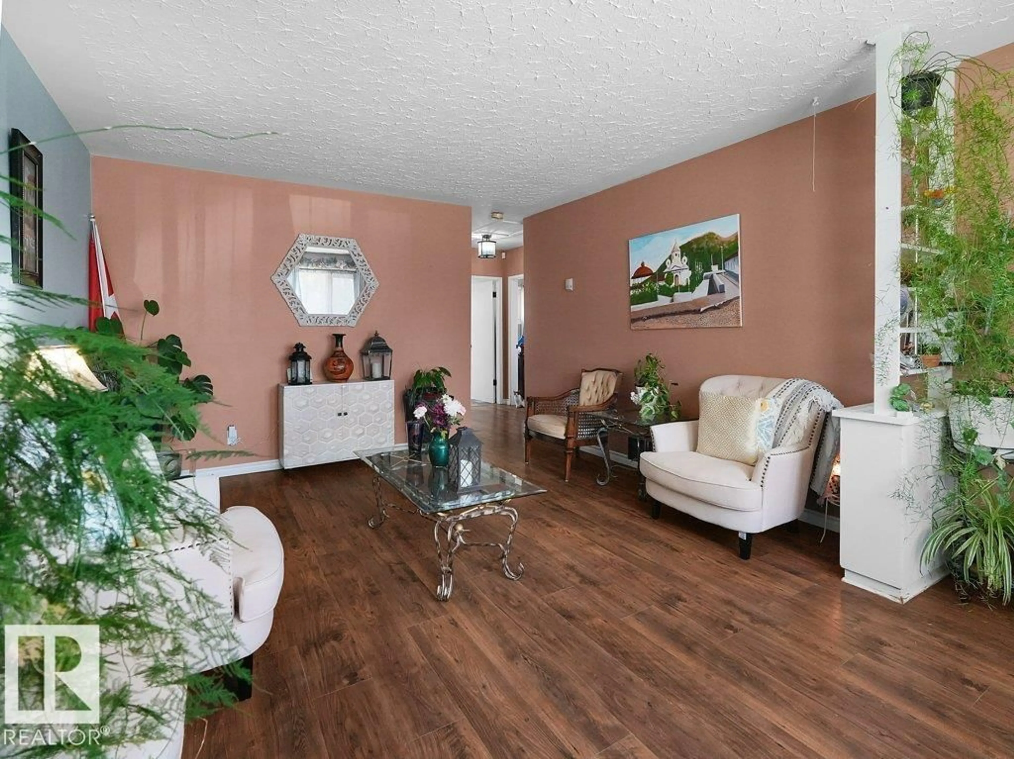 Living room with furniture, wood/laminate floor for 6324 132 AV, Edmonton Alberta T5A0J7