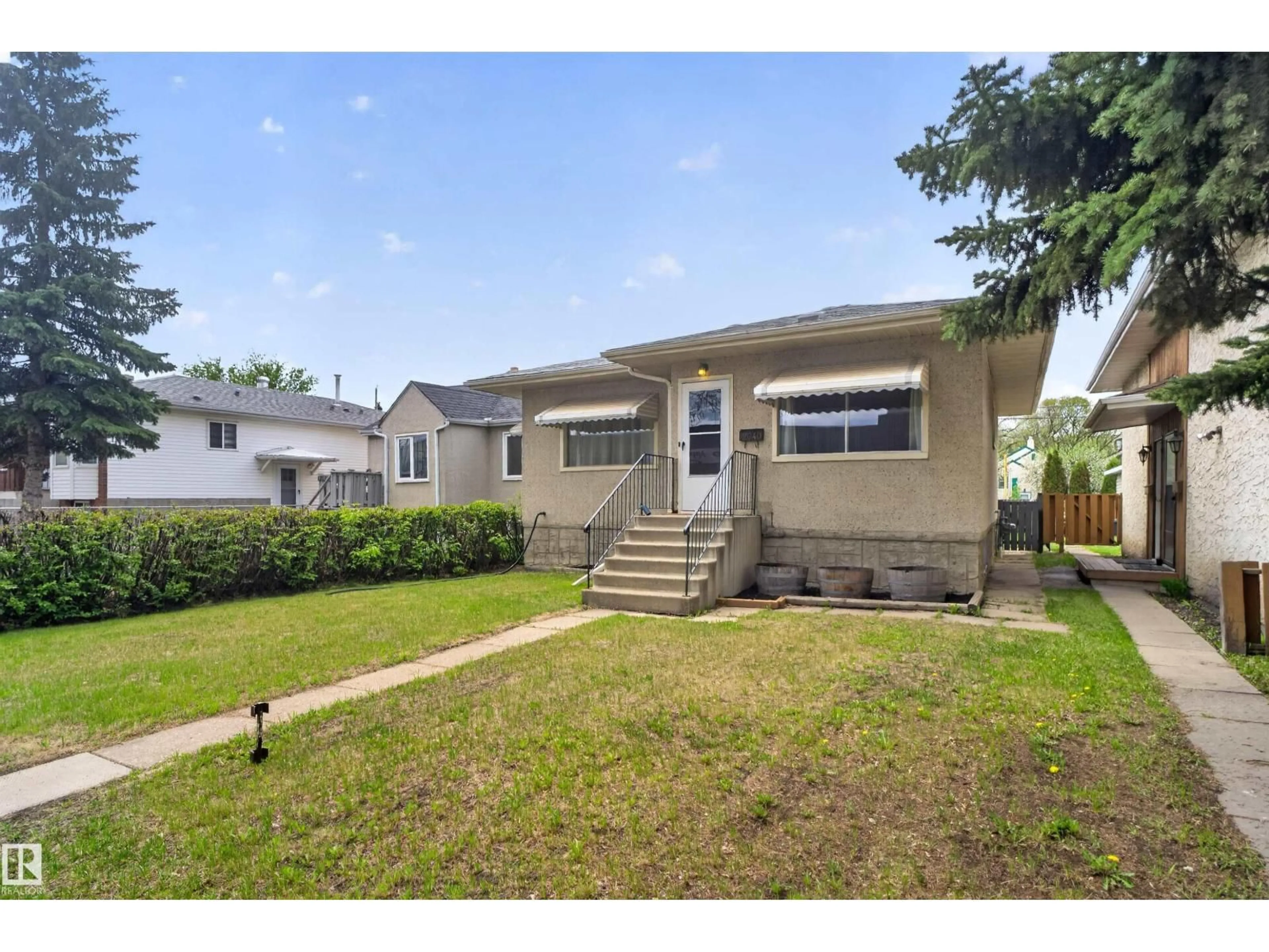 Home with vinyl exterior material, street for 12040 76 ST, Edmonton Alberta T5B2C8
