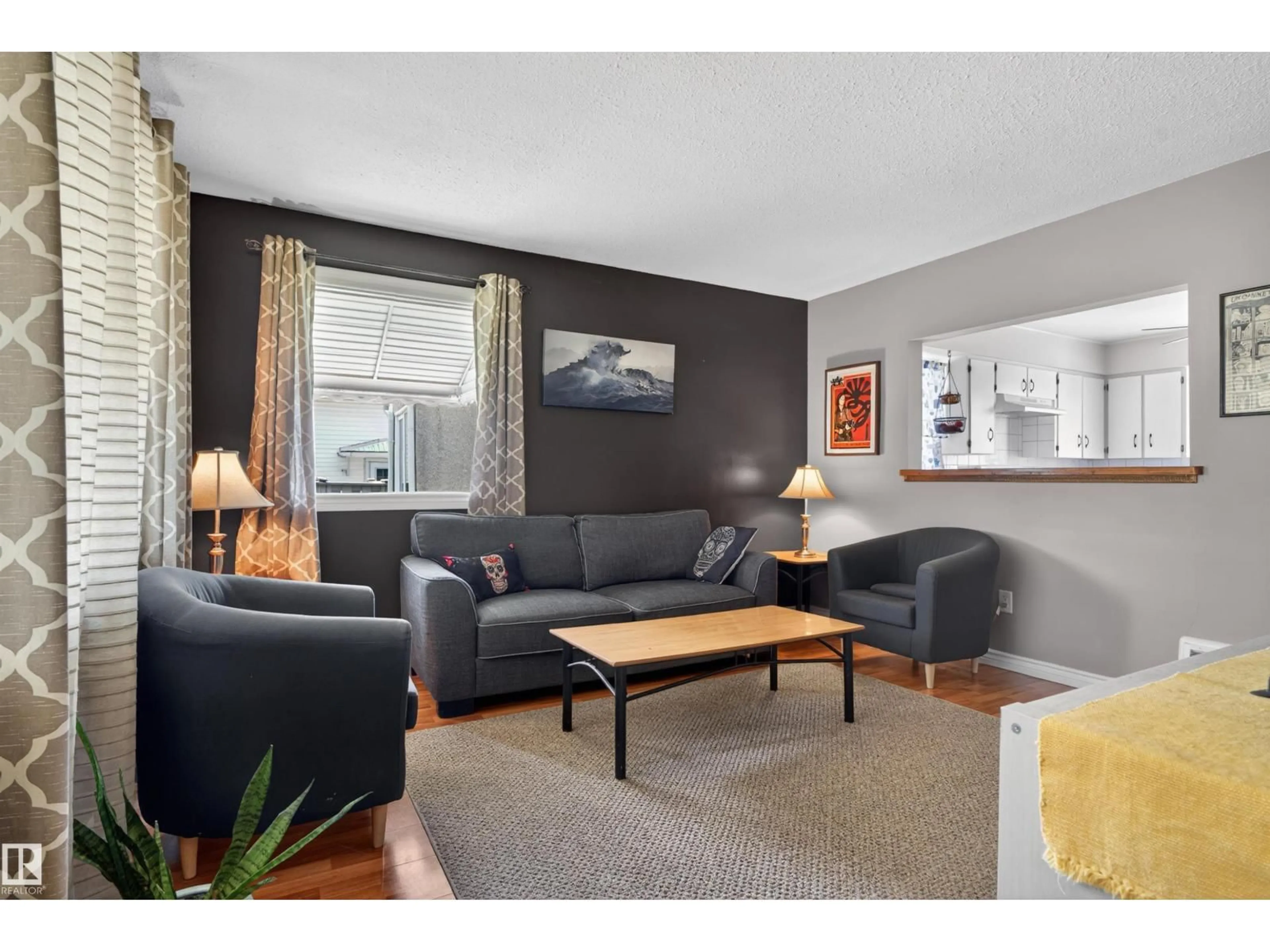 Living room with furniture, wood/laminate floor for 12040 76 ST, Edmonton Alberta T5B2C8