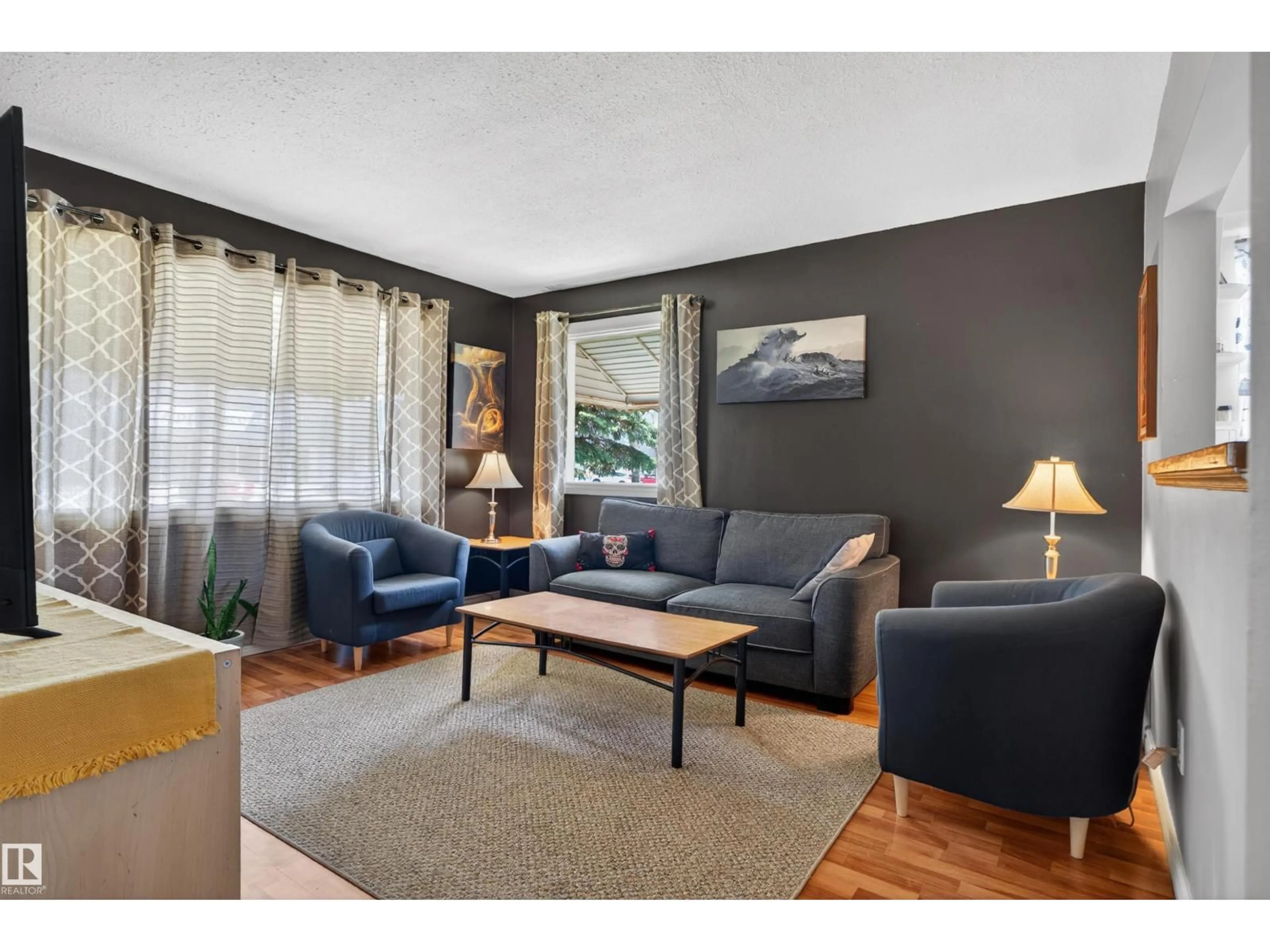 Living room with furniture, wood/laminate floor for 12040 76 ST, Edmonton Alberta T5B2C8
