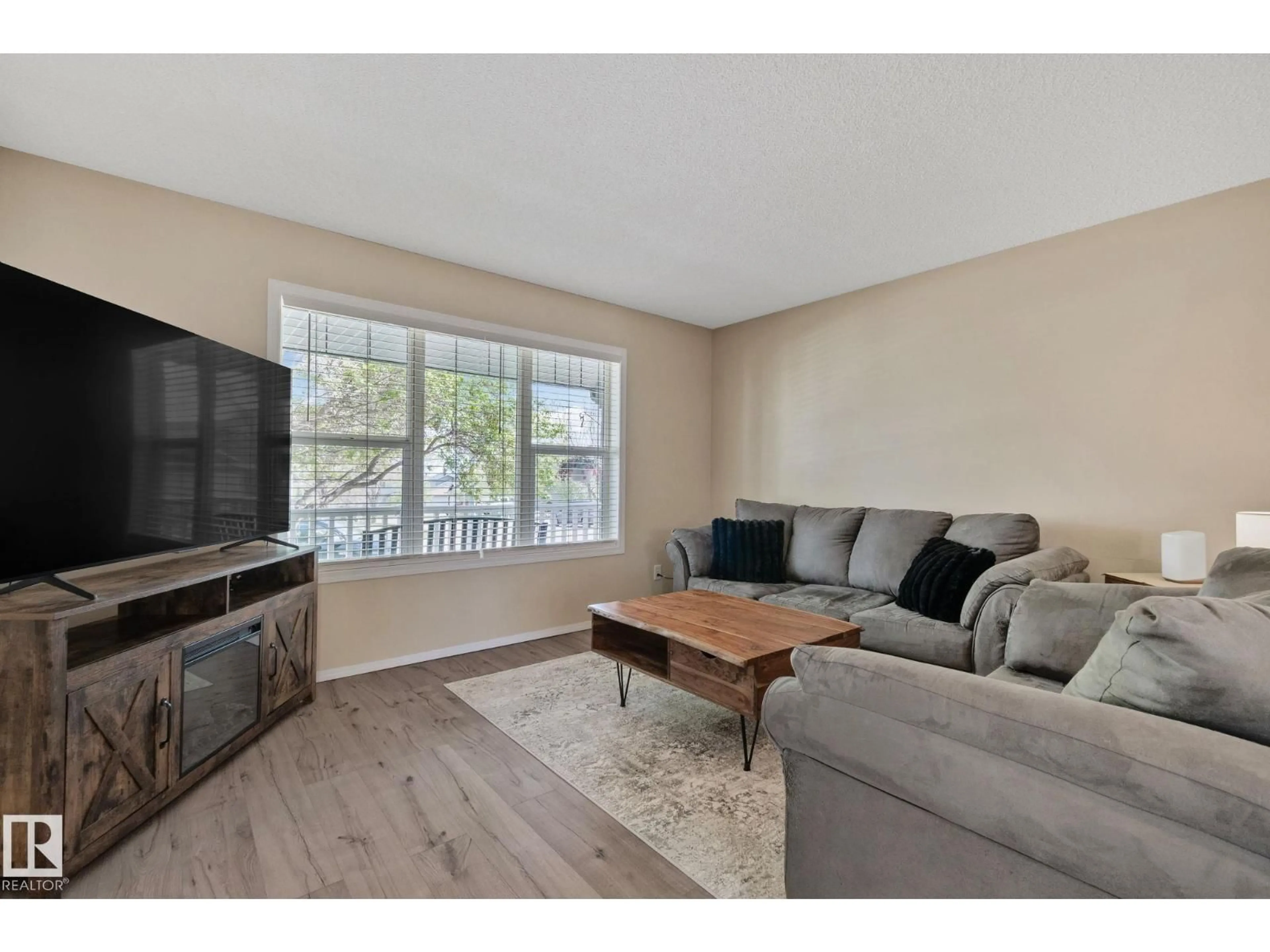 Living room with furniture, wood/laminate floor for 15608 44 ST, Edmonton Alberta T5Y3H1