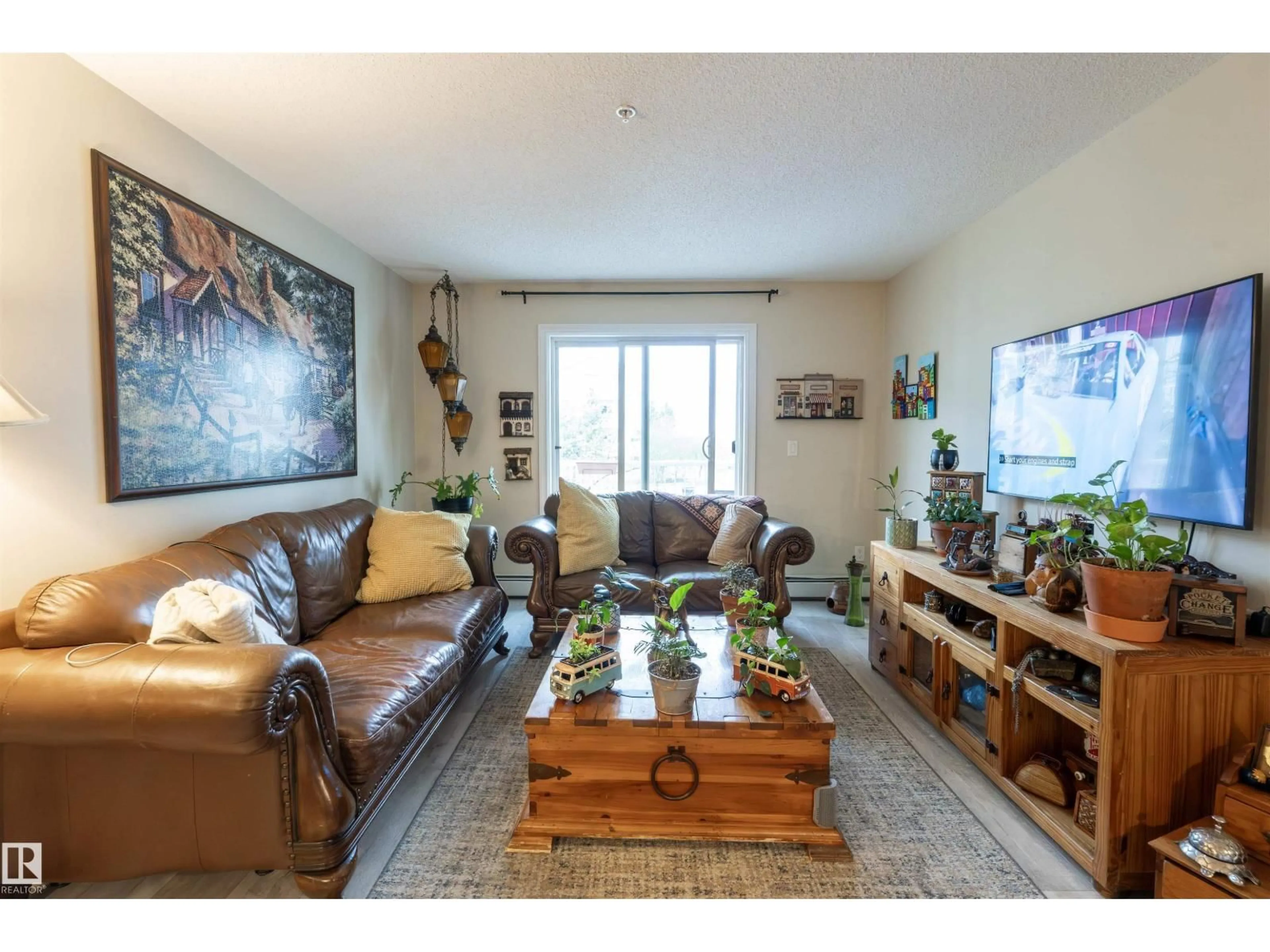 Living room with furniture, wood/laminate floor for #203 - 4403 23 ST, Edmonton Alberta T6T0E4
