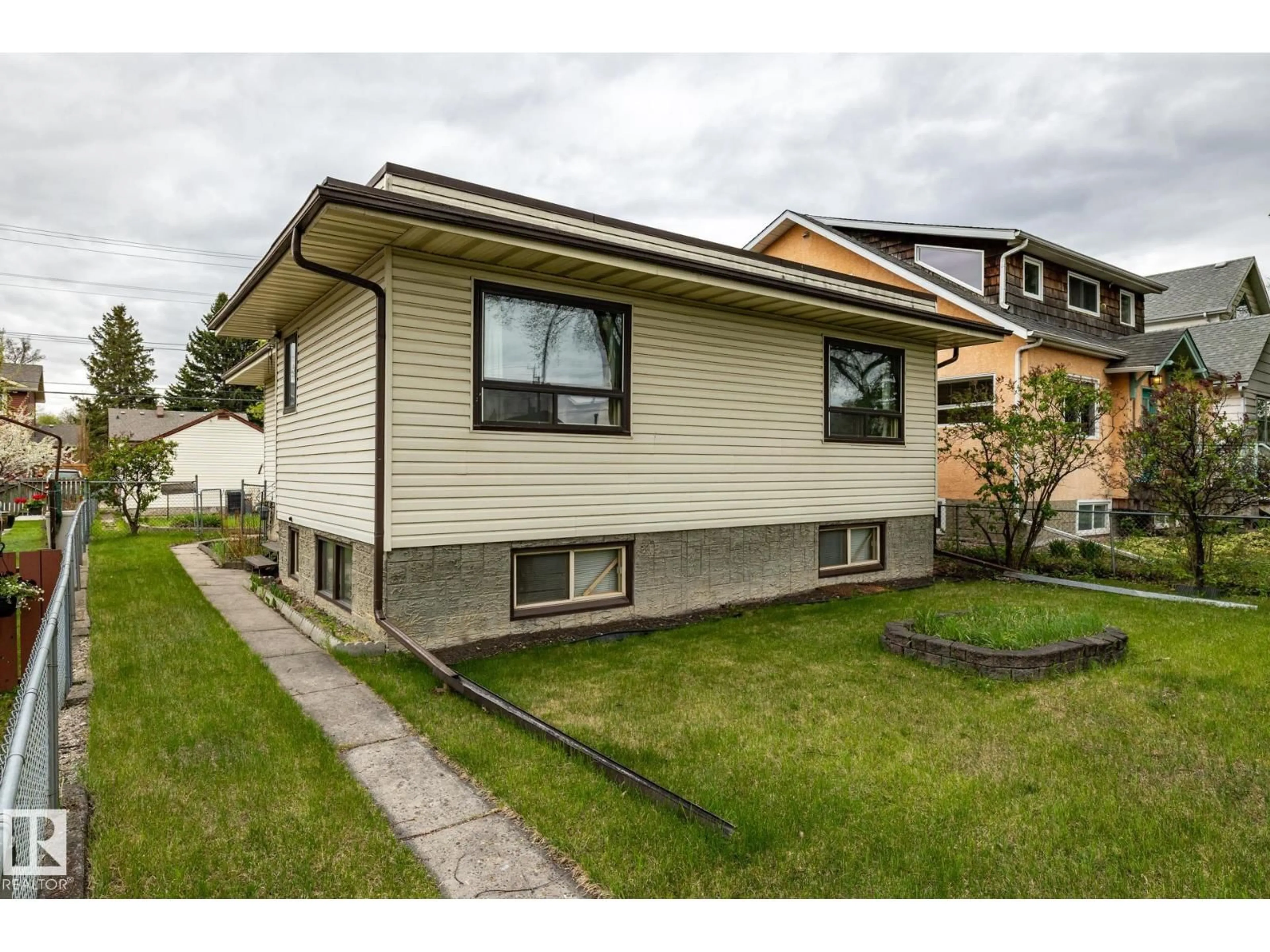 Home with vinyl exterior material, street for 9839 81 AV, Edmonton Alberta T6E1W4