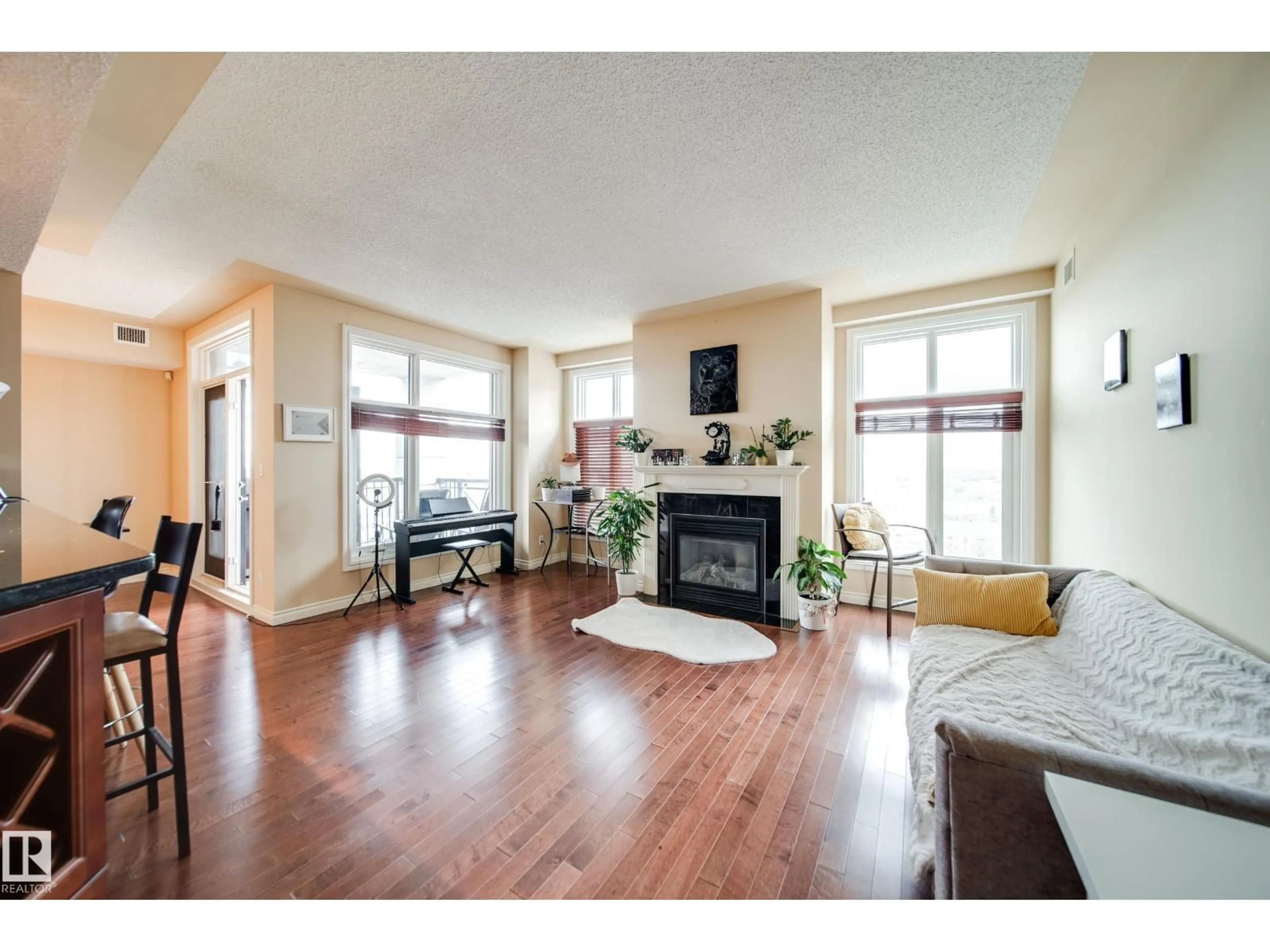 Living room with furniture, wood/laminate floor for 9020 - 1301 JASPER AV, Edmonton Alberta T5H3S8