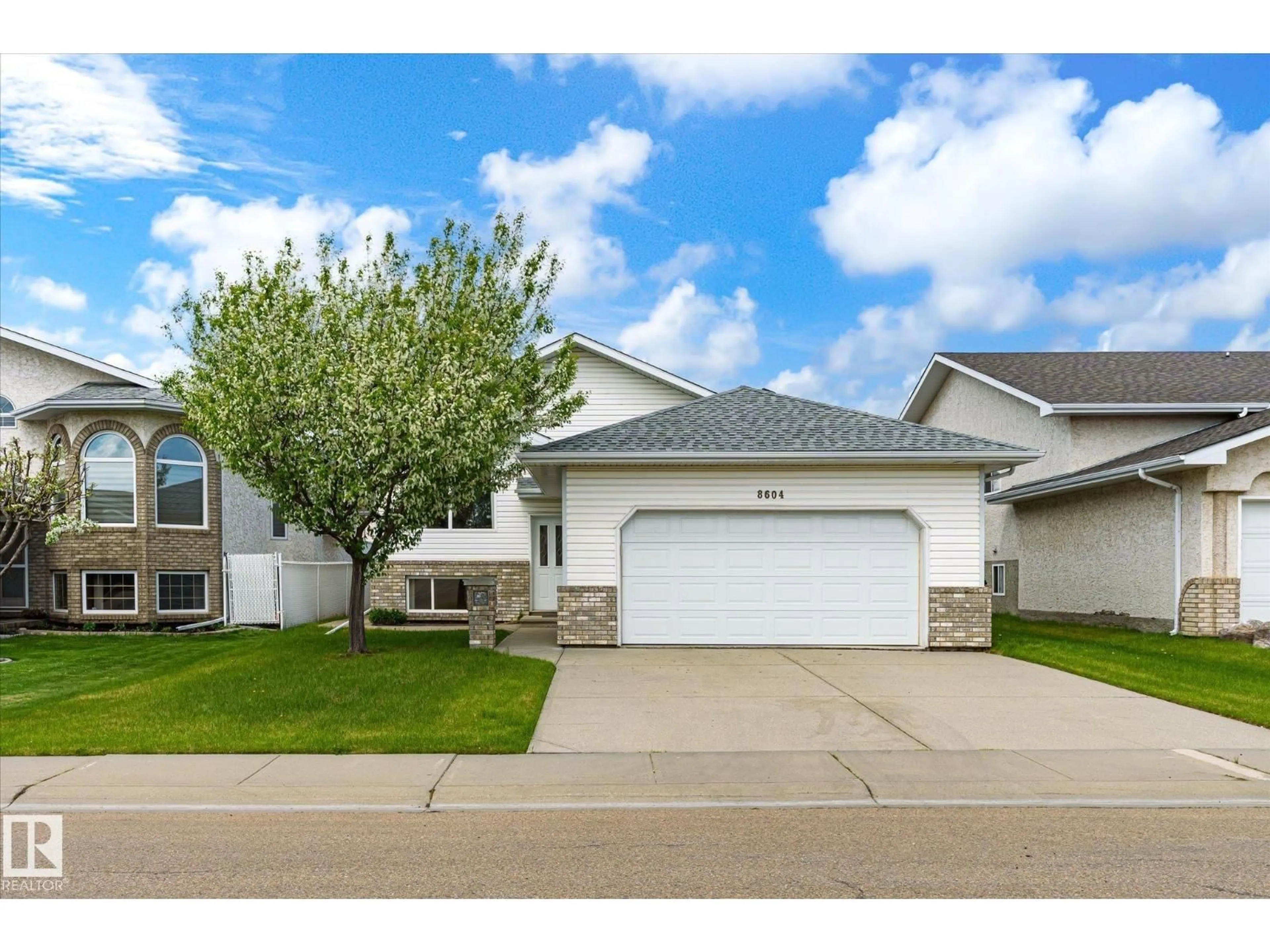 Home with vinyl exterior material, street for NW - 8604 157 AV, Edmonton Alberta T5Z3B3