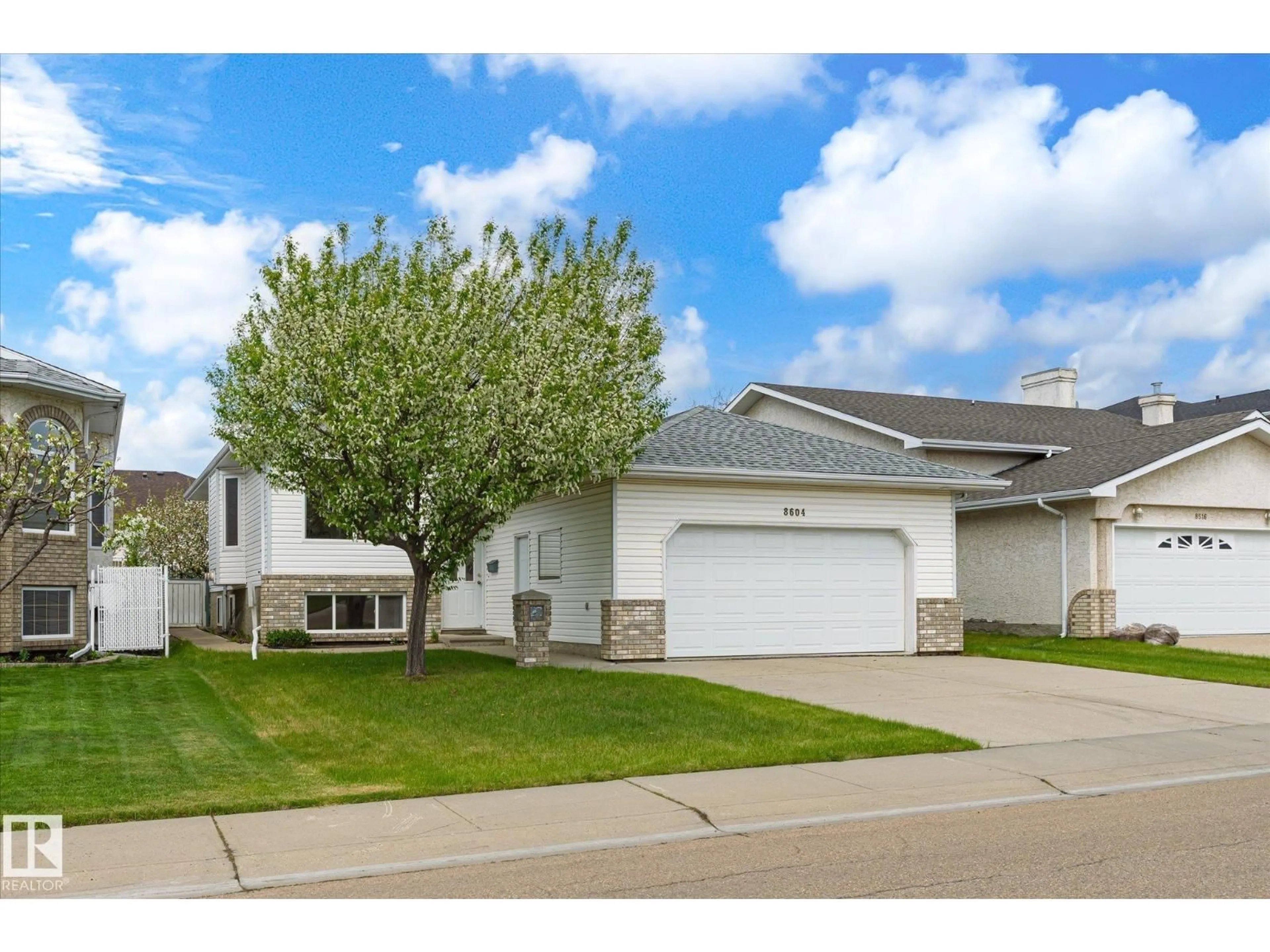 Home with vinyl exterior material, street for NW - 8604 157 AV, Edmonton Alberta T5Z3B3