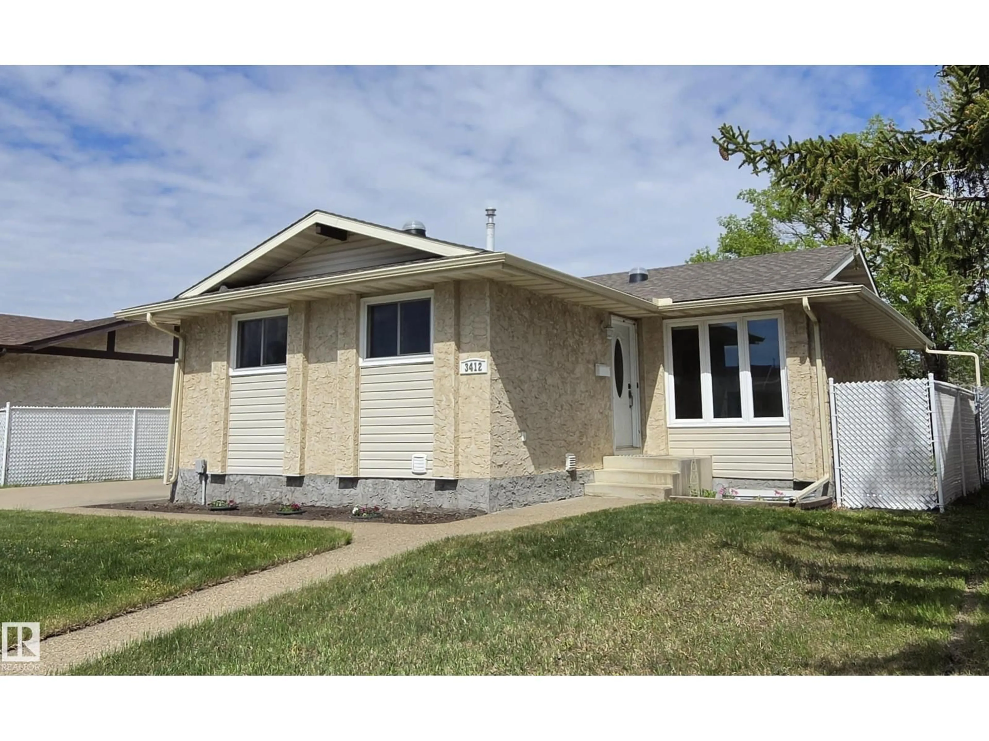 Home with vinyl exterior material, street for 3412 142 AV, Edmonton Alberta T5Y1H8