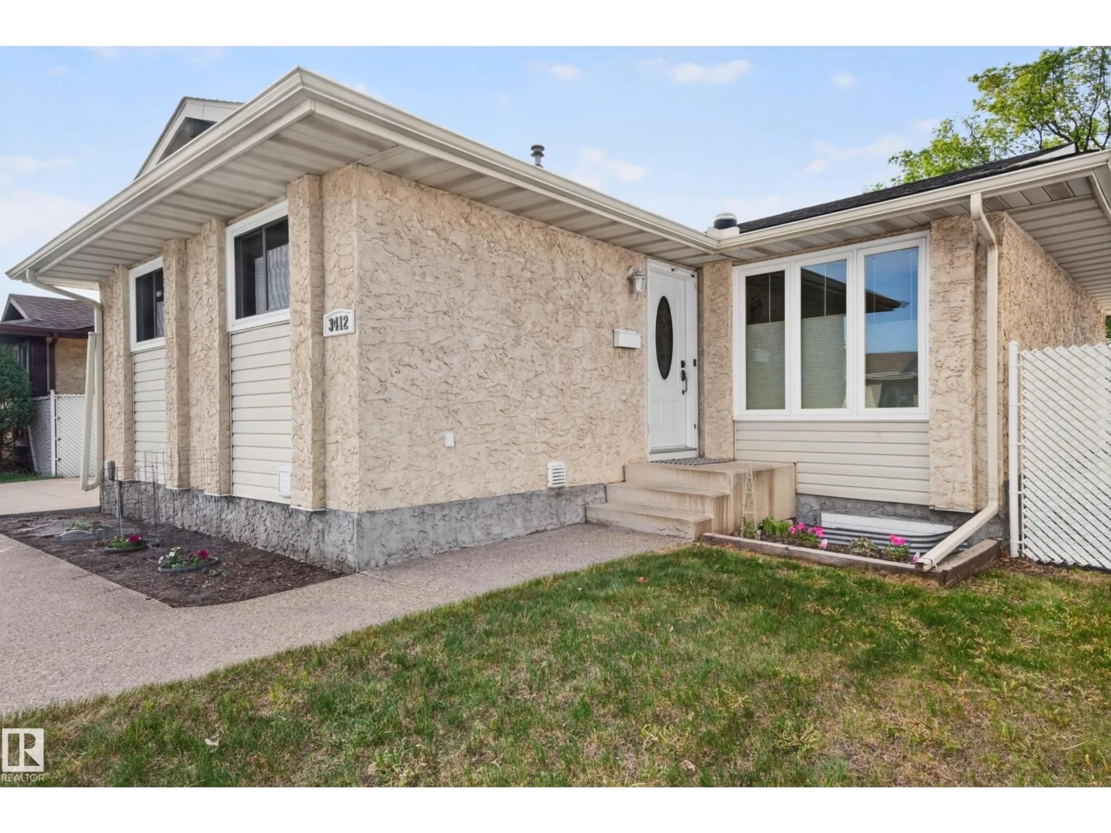 Home with brick exterior material, street for 3412 142 AV, Edmonton Alberta T5Y1H8