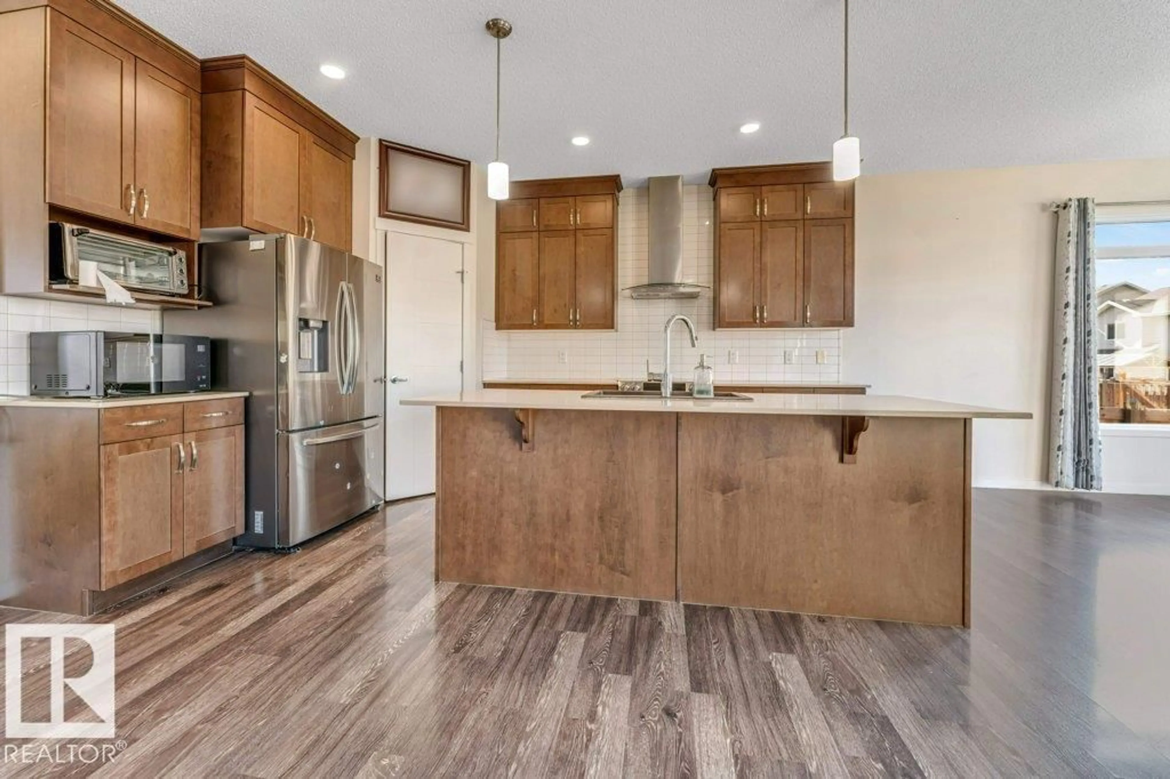 Open concept kitchen, wood/laminate floor for 1224 25 AV, Edmonton Alberta T6T2E5
