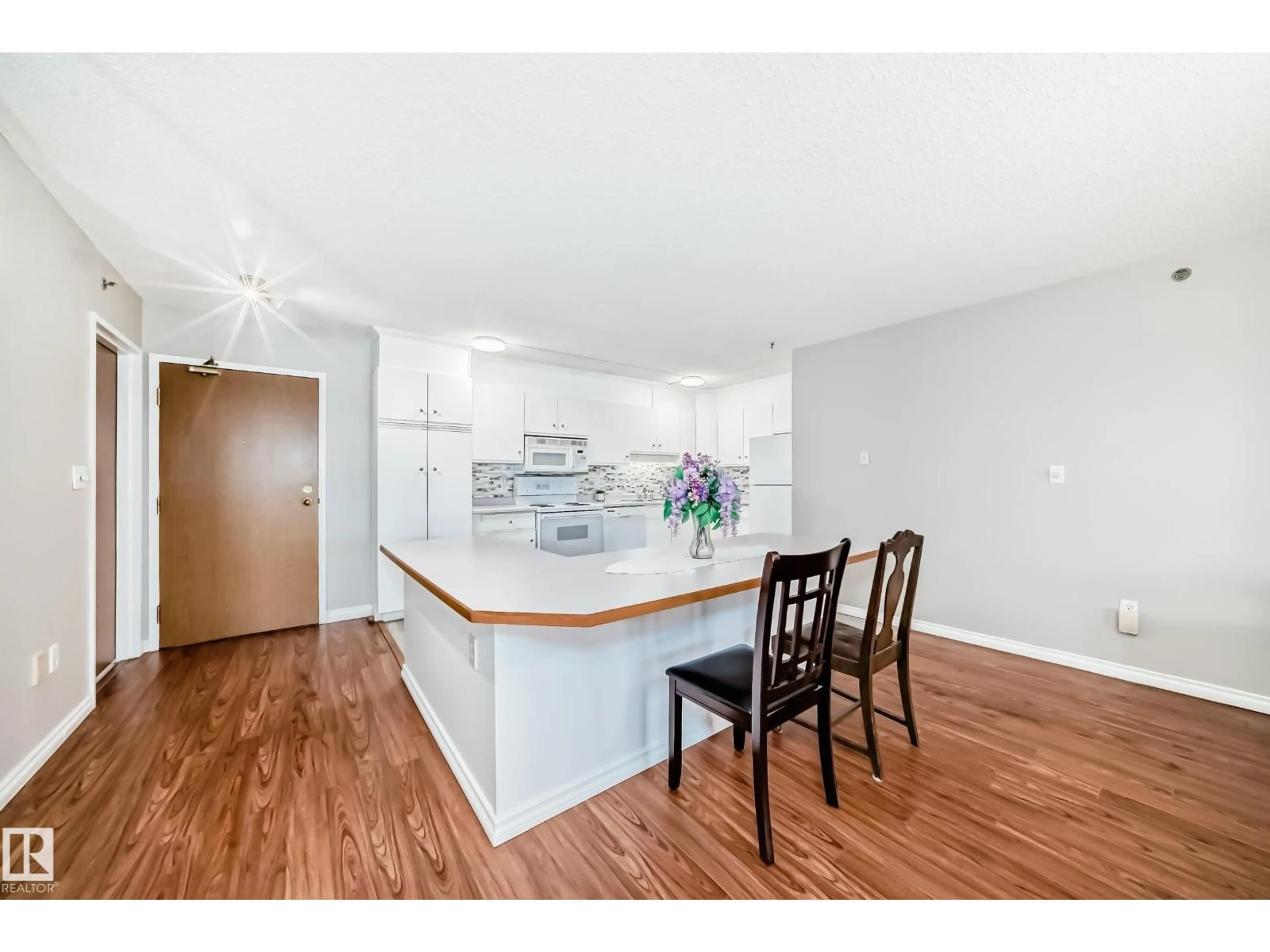 Open concept kitchen, wood/laminate floor for 311 - 4906 47 AV, Leduc Alberta T9E6R7