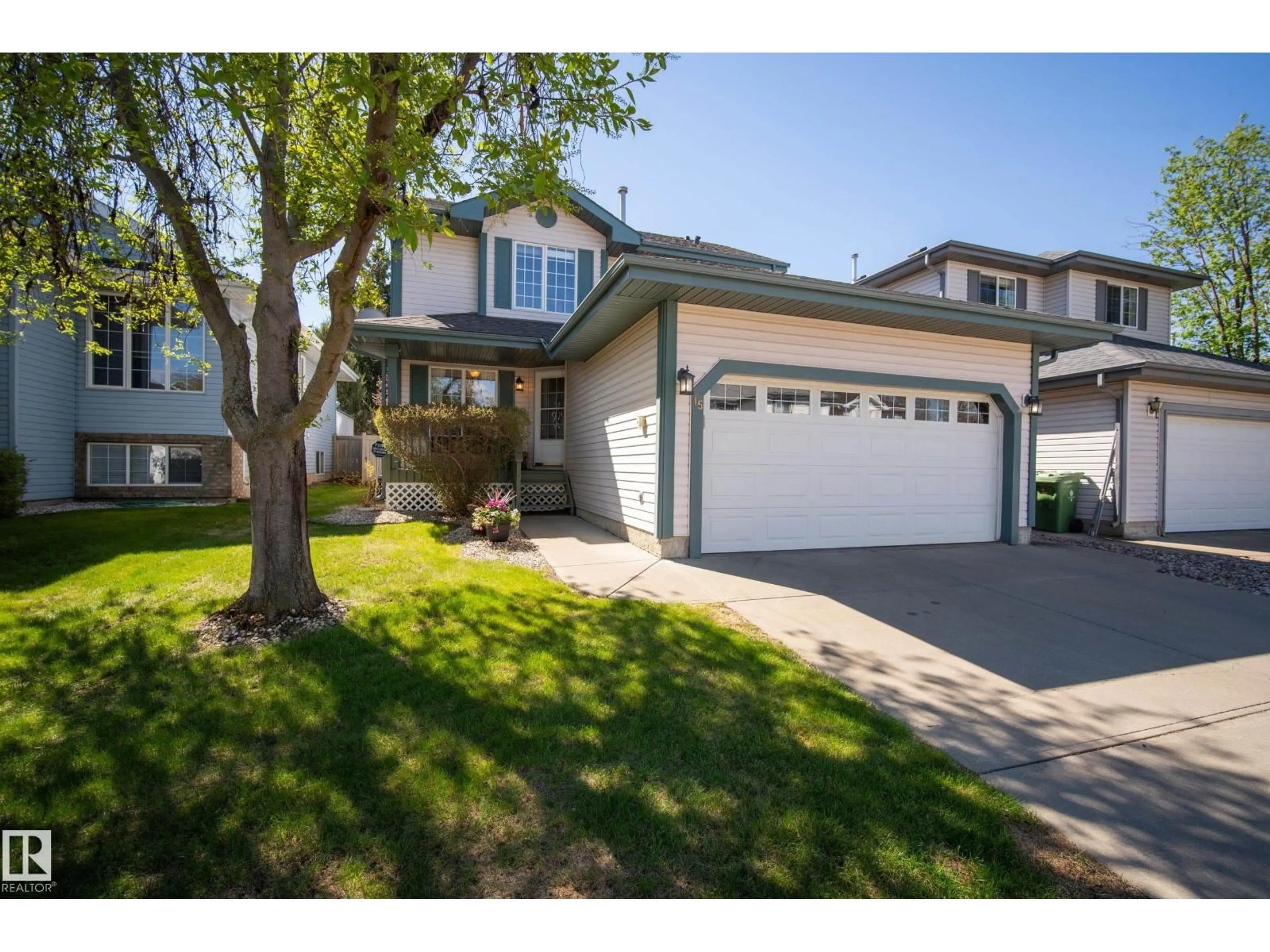 Home with vinyl exterior material, street for 15 WESTWOOD GR, Fort Saskatchewan Alberta T8L4G3