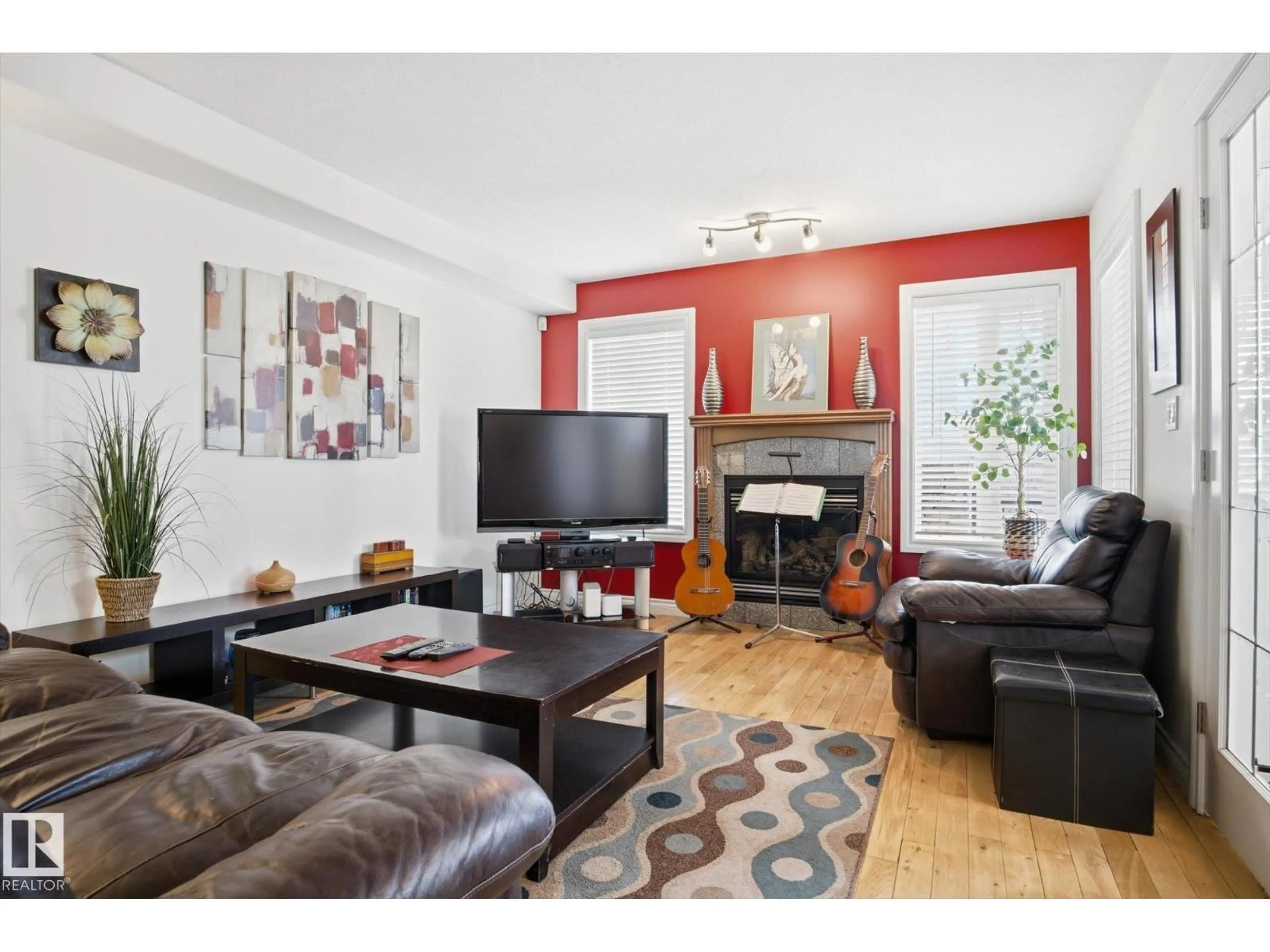 Living room with furniture, wood/laminate floor for 12009 102 ST, Edmonton Alberta T5G2G6
