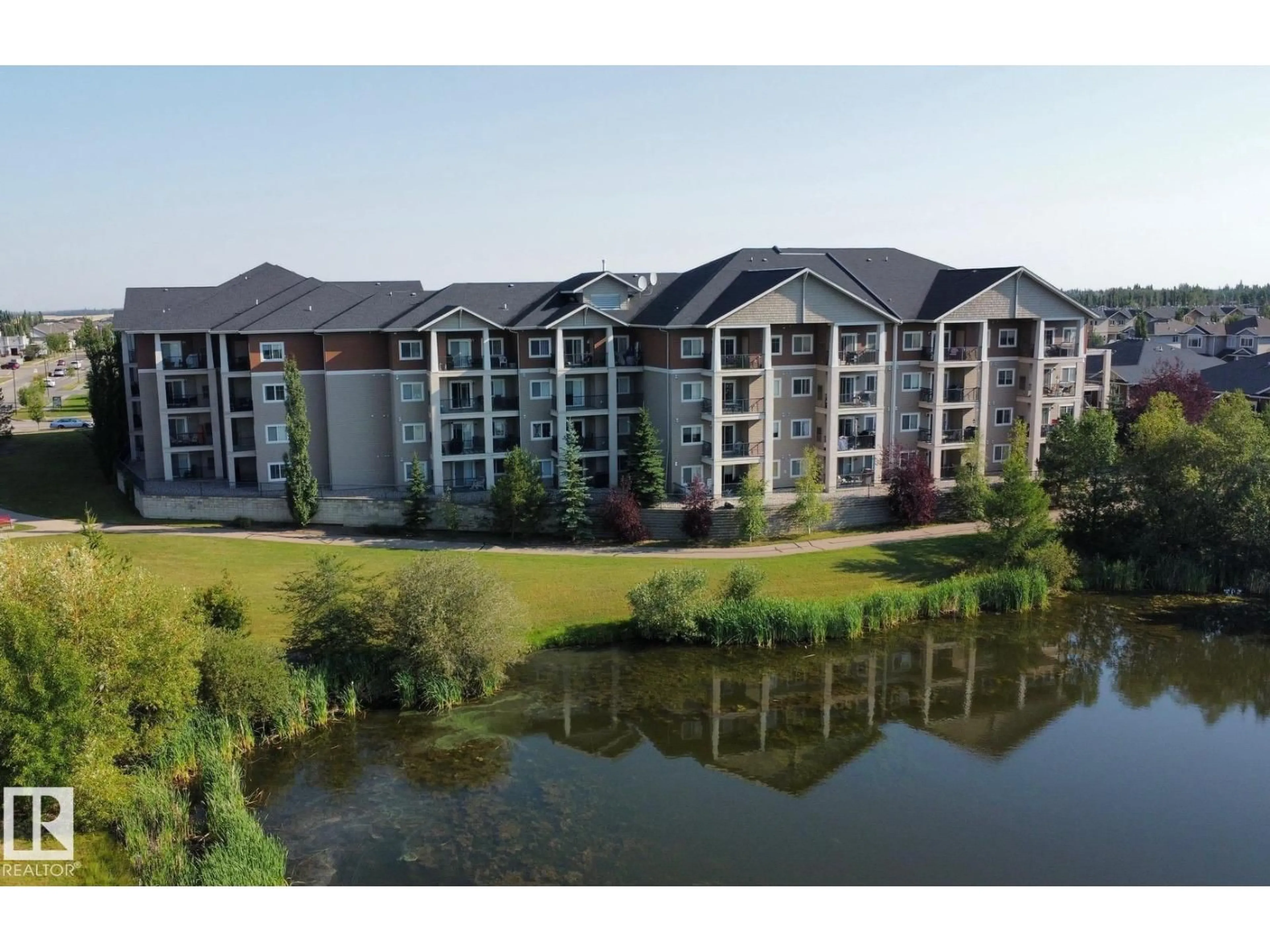 A pic from outside/outdoor area/front of a property/back of a property/a pic from drone, water/lake/river/ocean view for #208 - 105 WEST HAVEN DR, Leduc Alberta T9E0R9