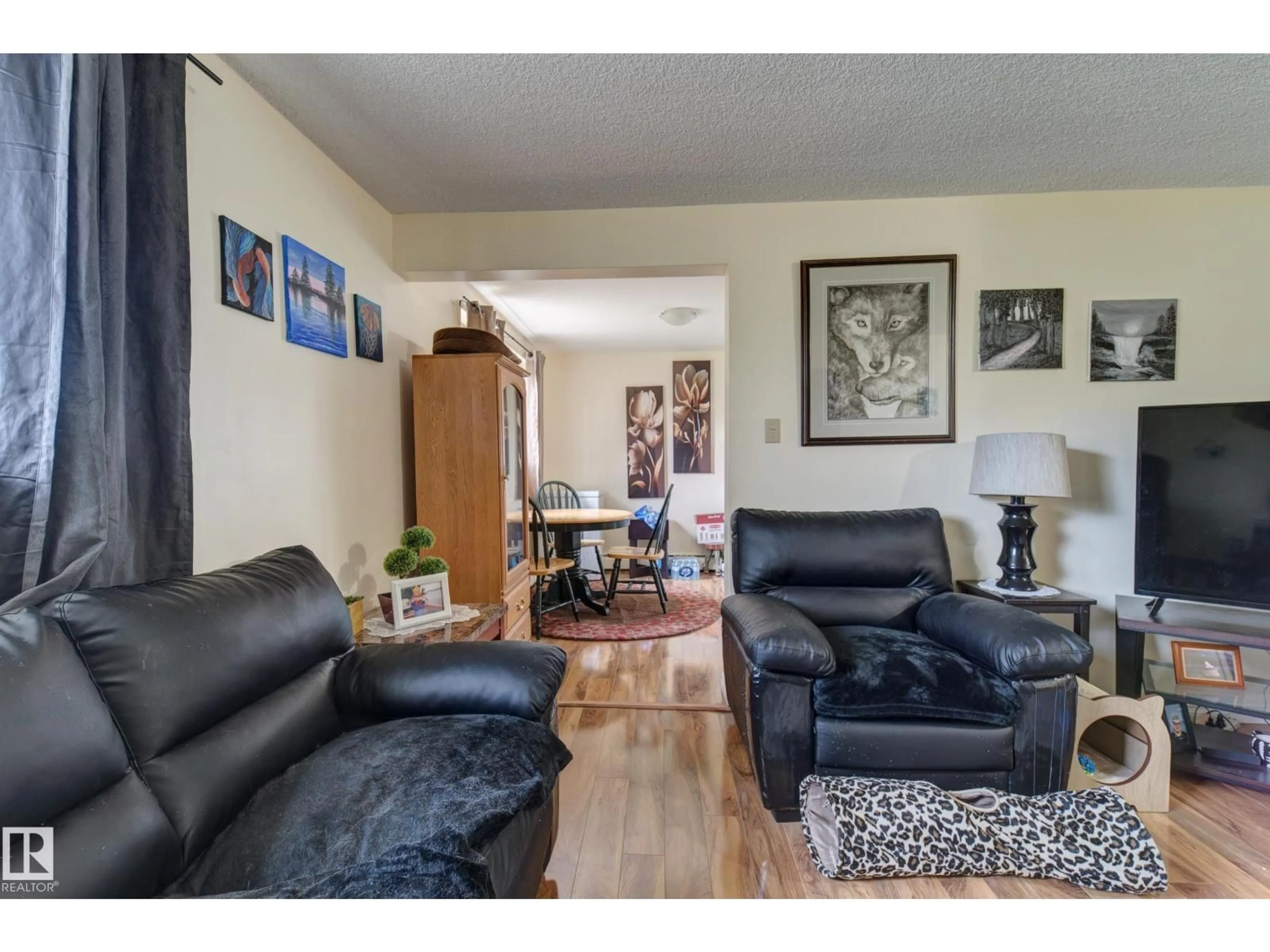 Living room with furniture, wood/laminate floor for NW - 9749 88 AV, Edmonton Alberta T6E2R1