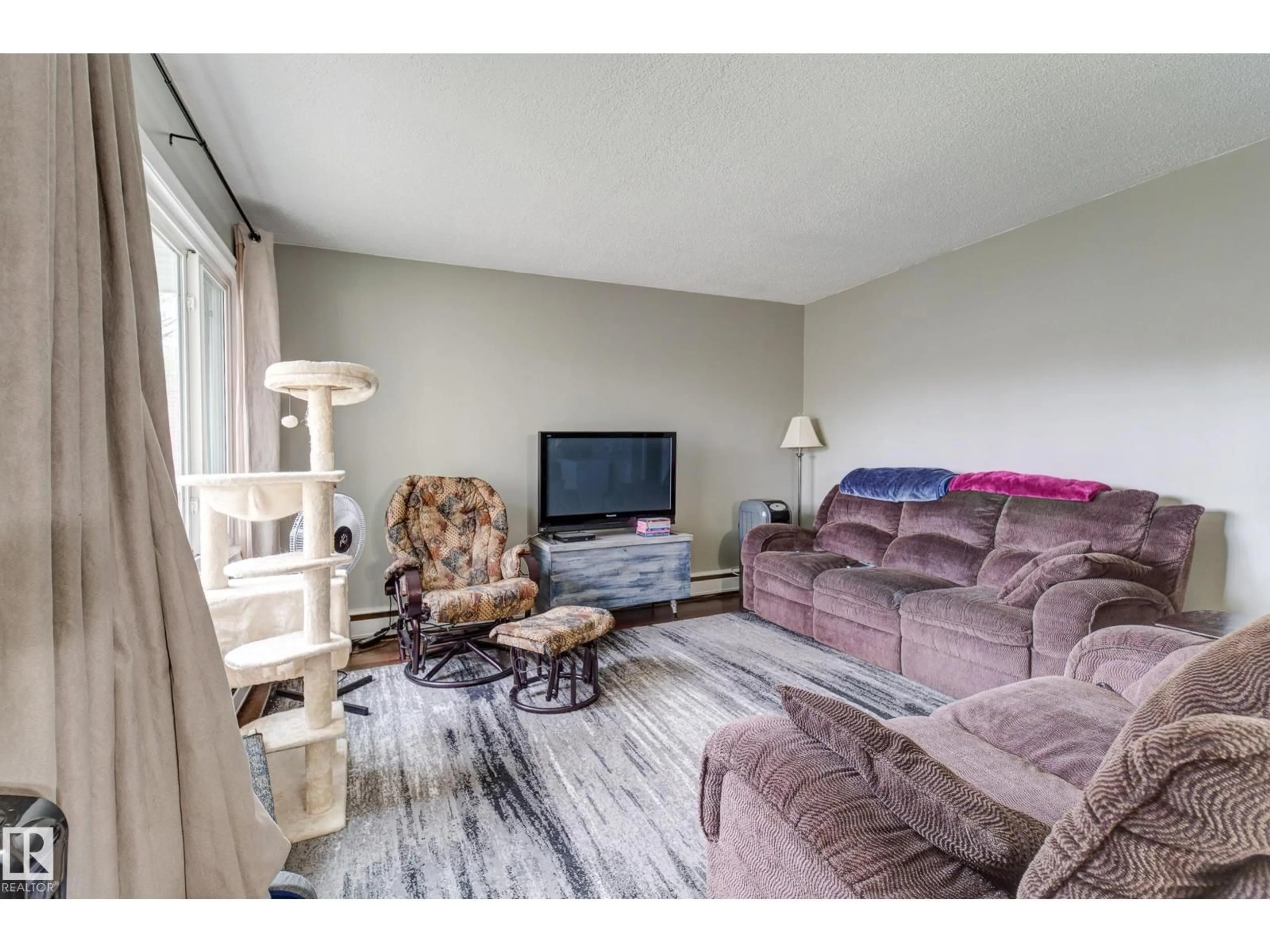 Living room with furniture, wood/laminate floor for 10524 78 ST, Edmonton Alberta T6A3E9