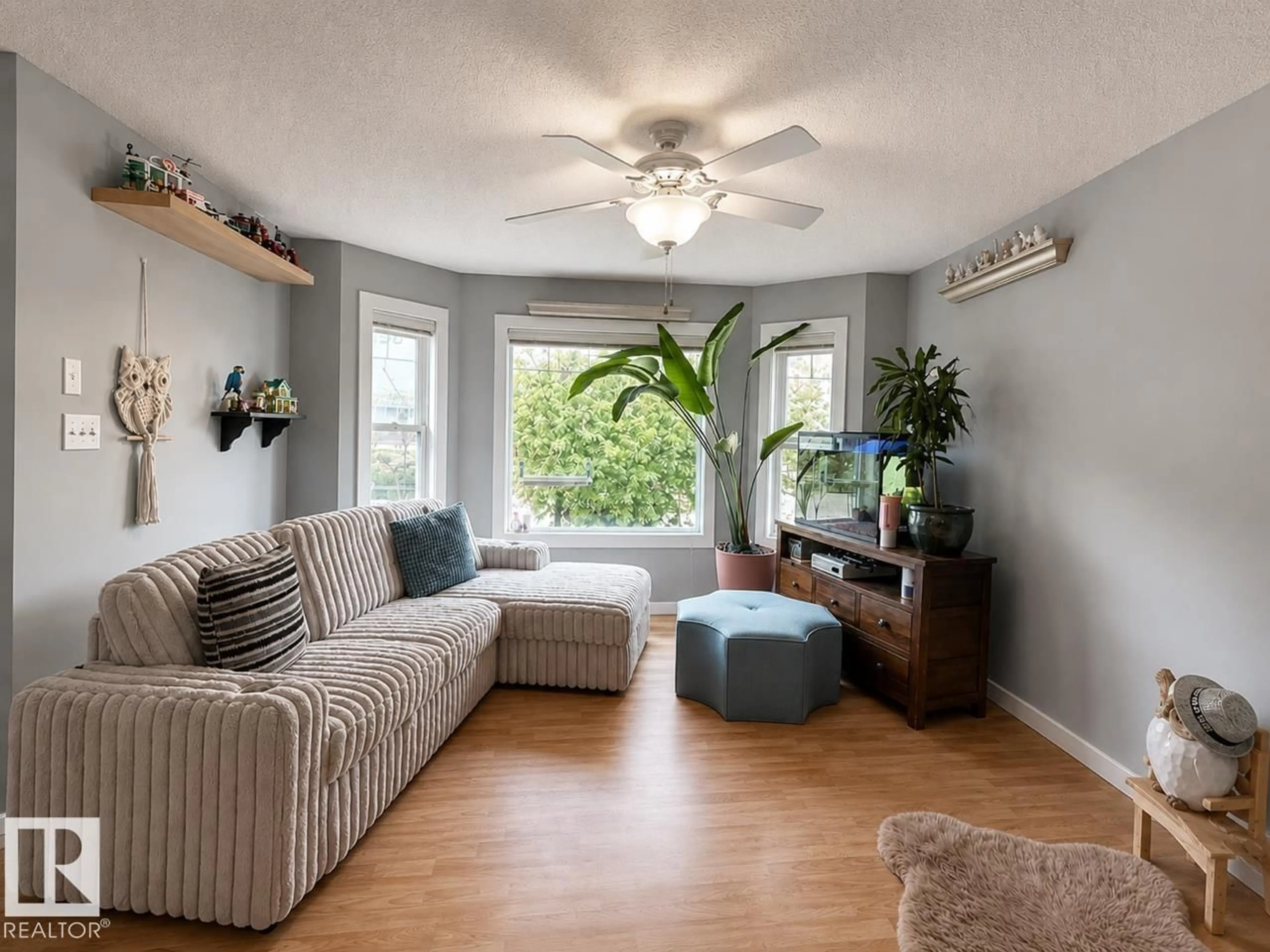 Living room with furniture, wood/laminate floor for 105 KEYSTONE CR, Leduc Alberta T9E0J4