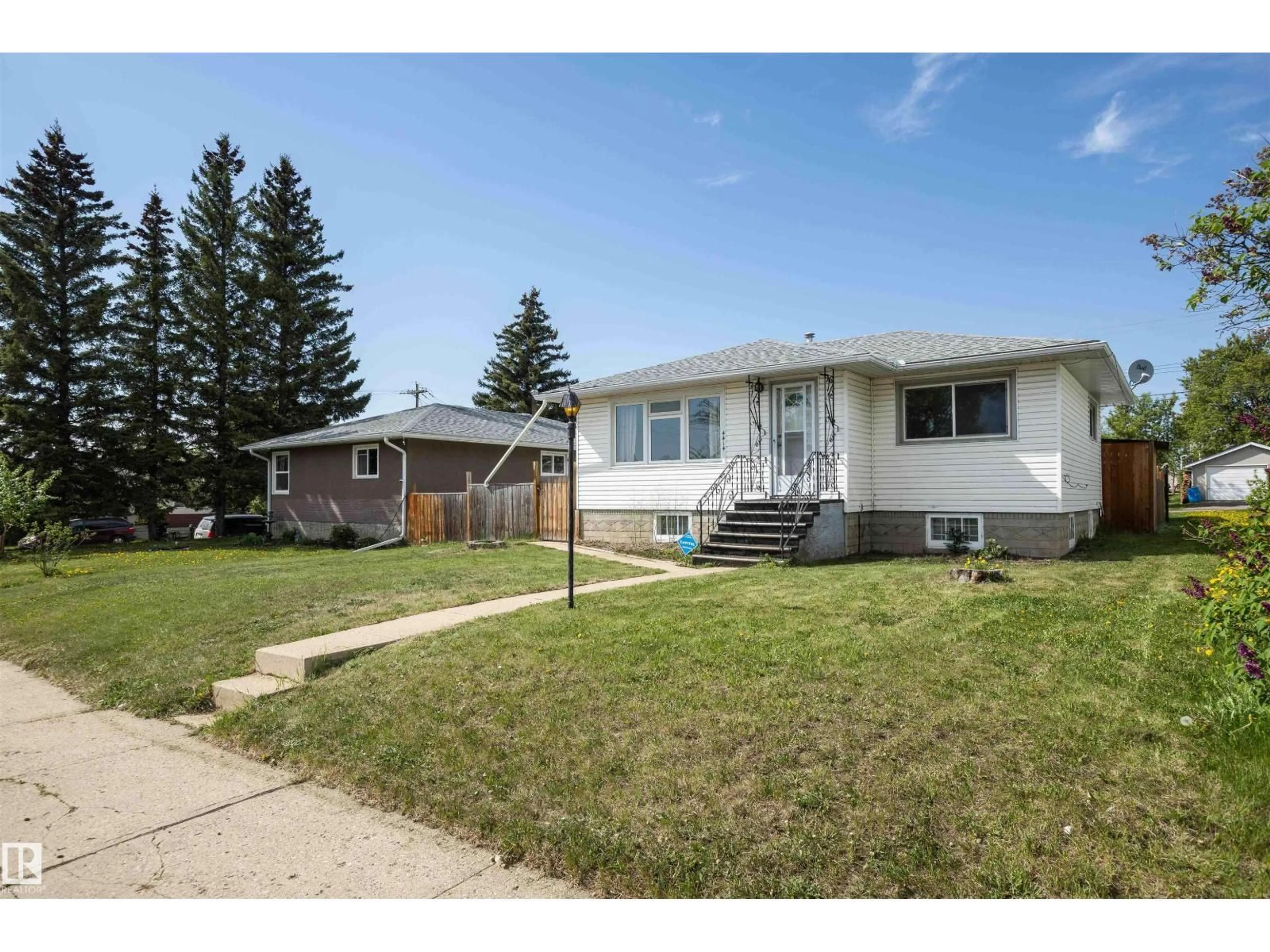 Home with vinyl exterior material, street for 4414 54 AV, Barrhead Alberta T7N1J9