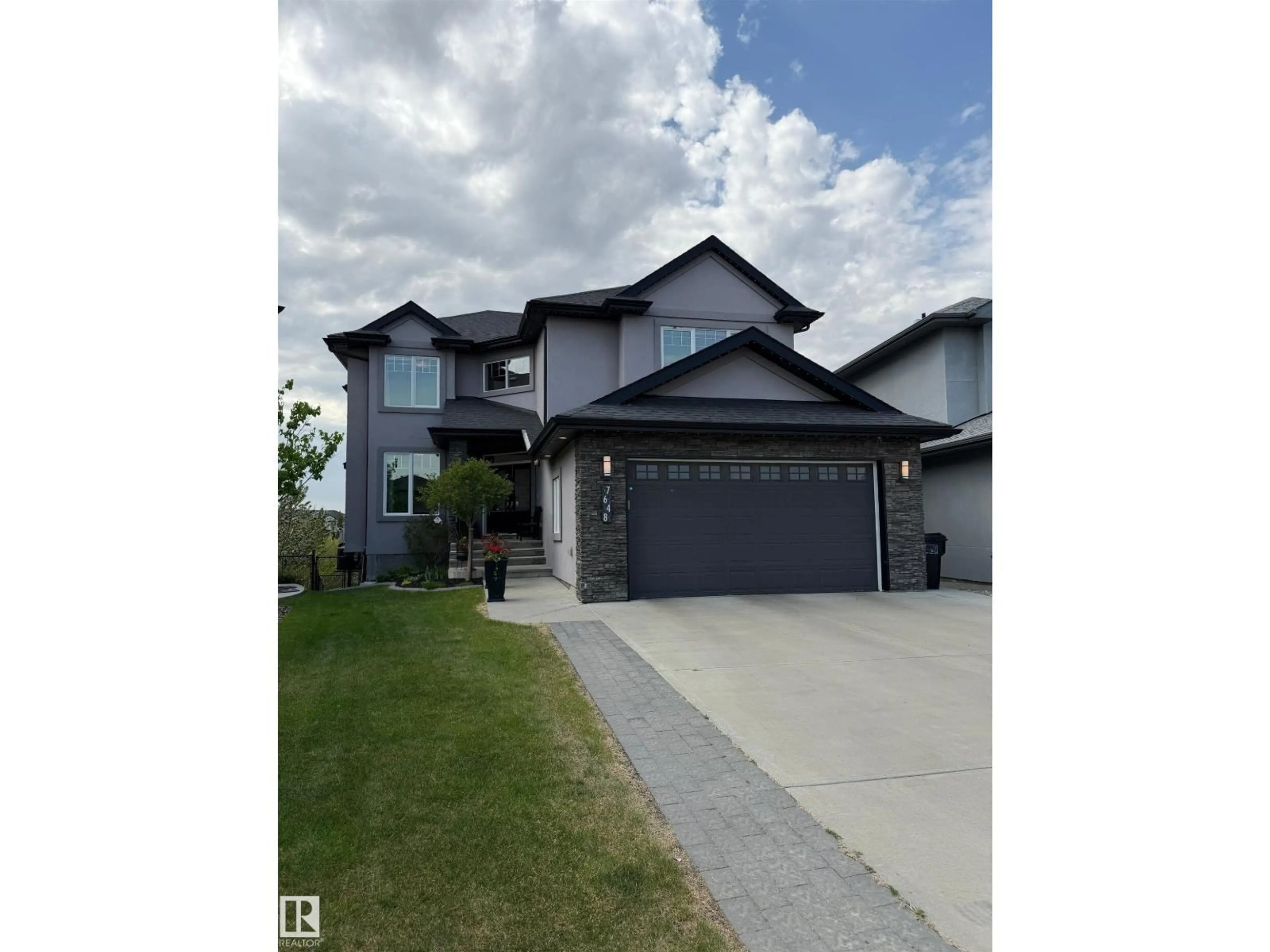 Home with vinyl exterior material, street for 7648 179 AV, Edmonton Alberta T5Z0L2