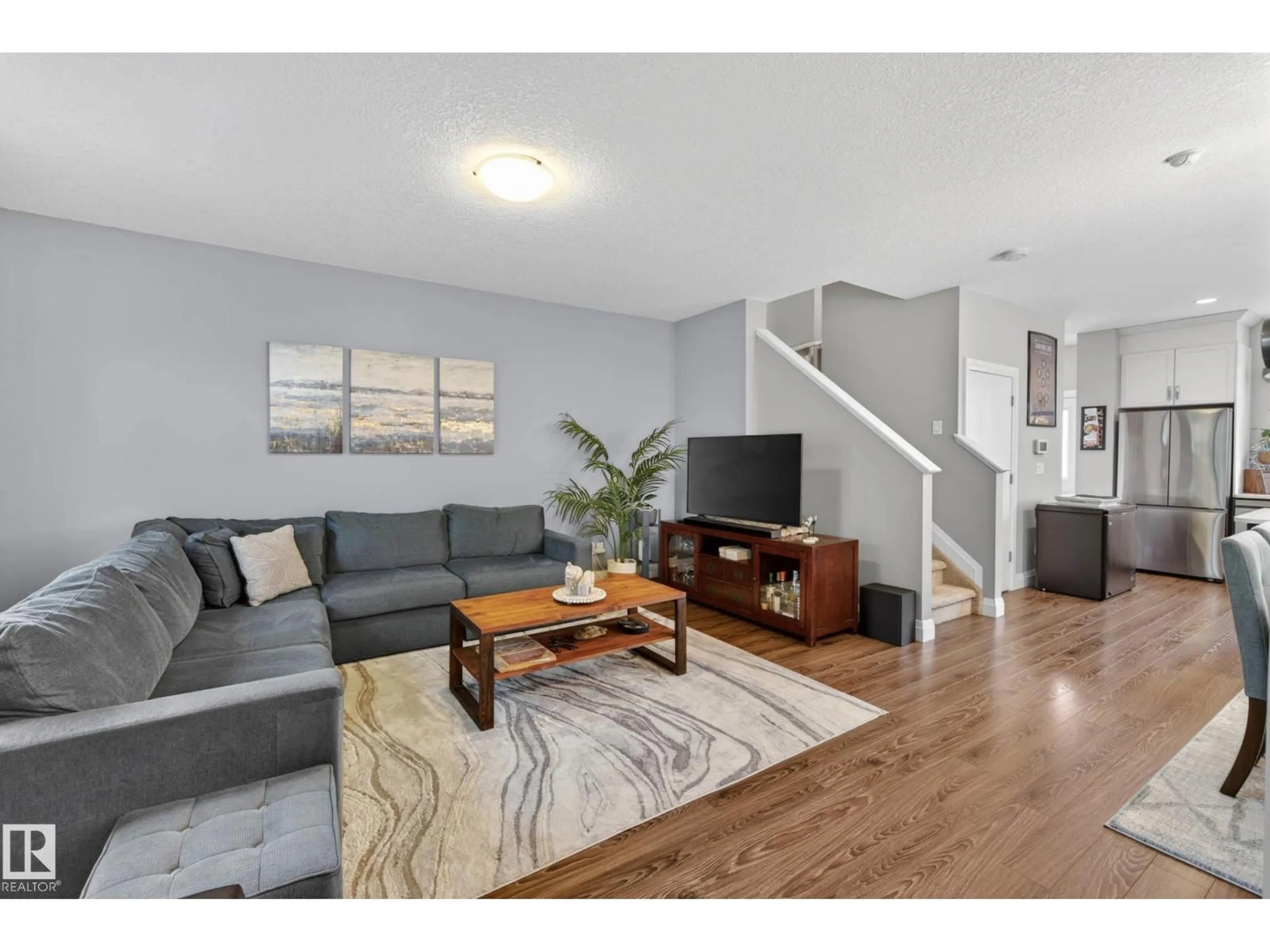 Living room with furniture, wood/laminate floor for 52 GILMORE WY, Spruce Grove Alberta T7X0M5