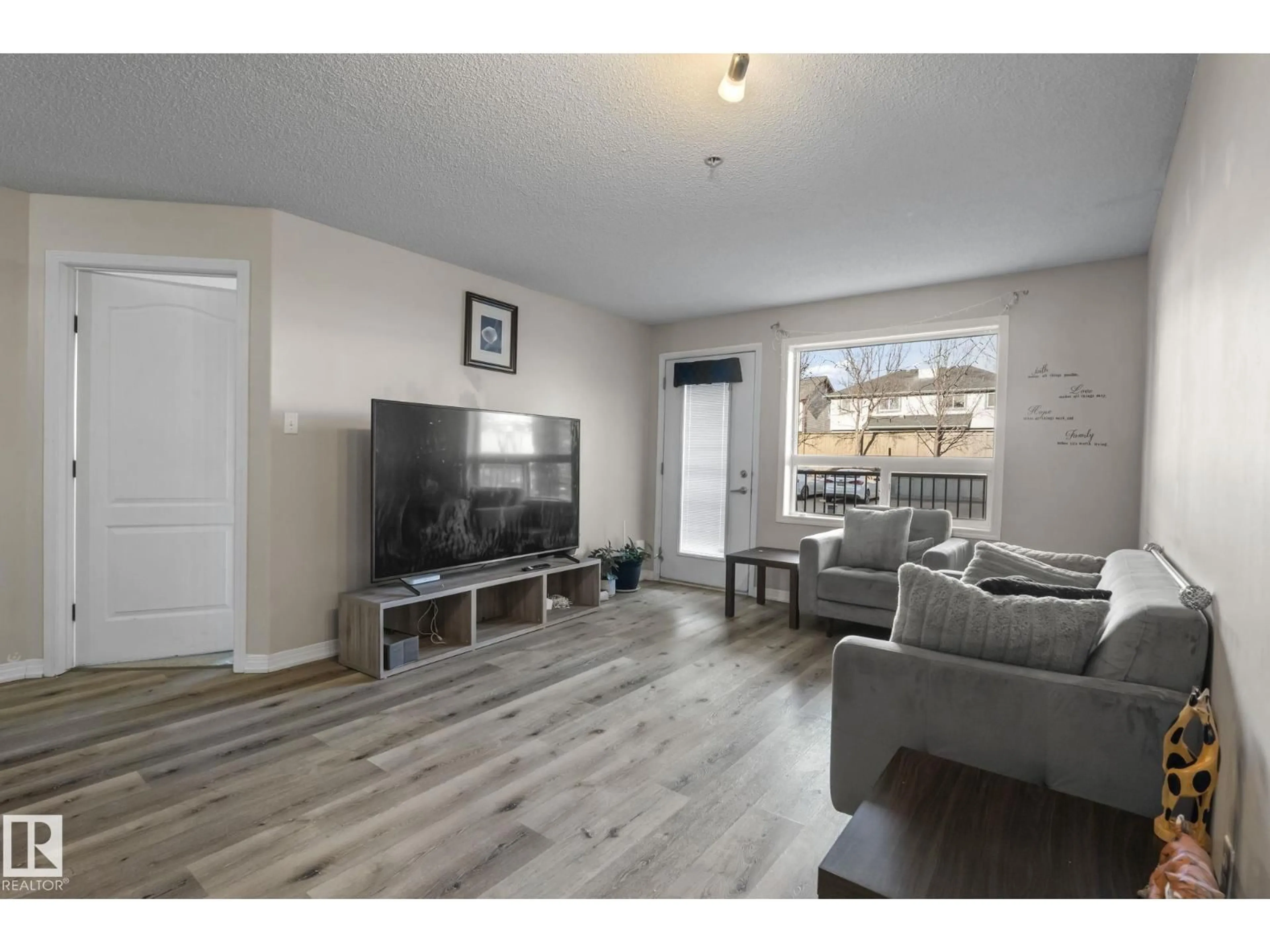 Living room with furniture, wood/laminate floor for 9357 - 2106 SIMPSON DR, Edmonton Alberta T6R0N3
