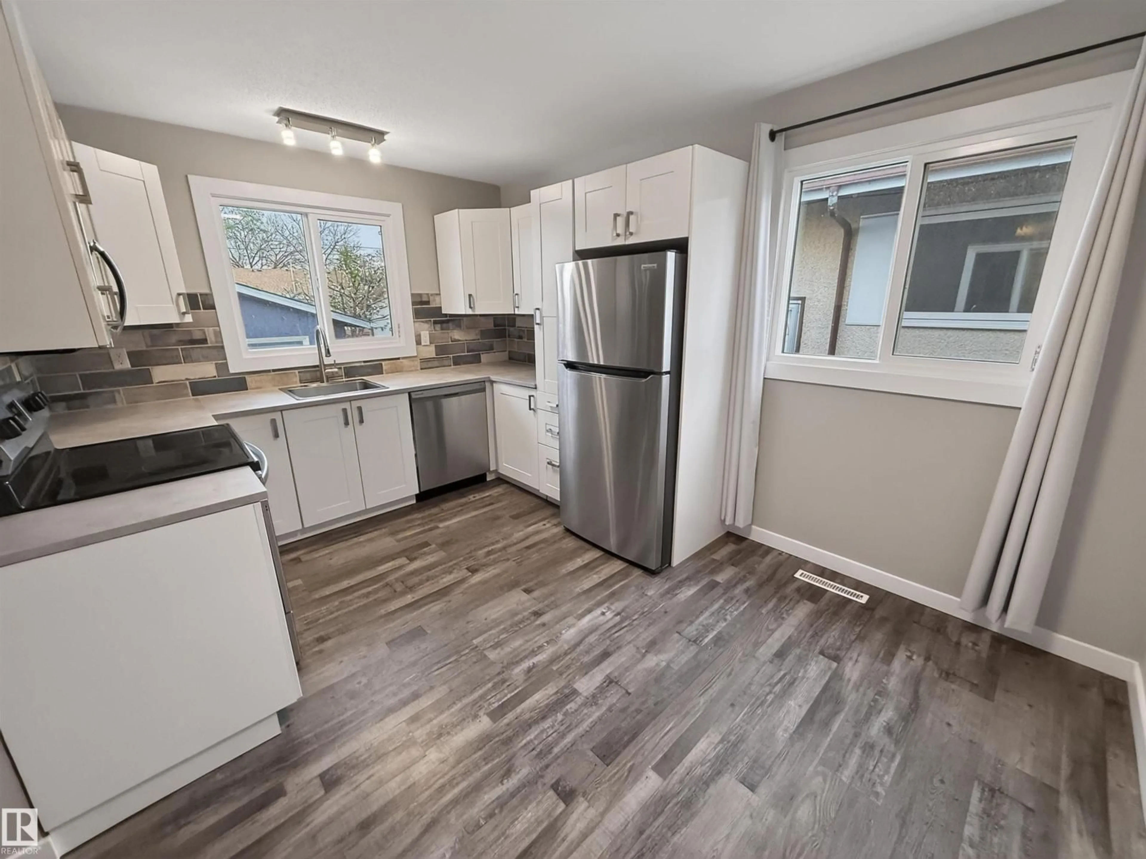 Open concept kitchen, wood/laminate floor for NW - 12943 123 ST, Edmonton Alberta T5L0J6